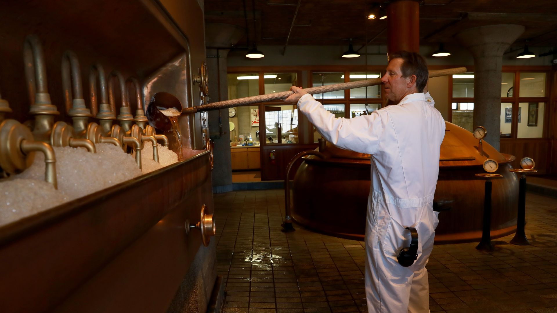Photo of a person operating brewing equipment in Anchor Brewing Company's building