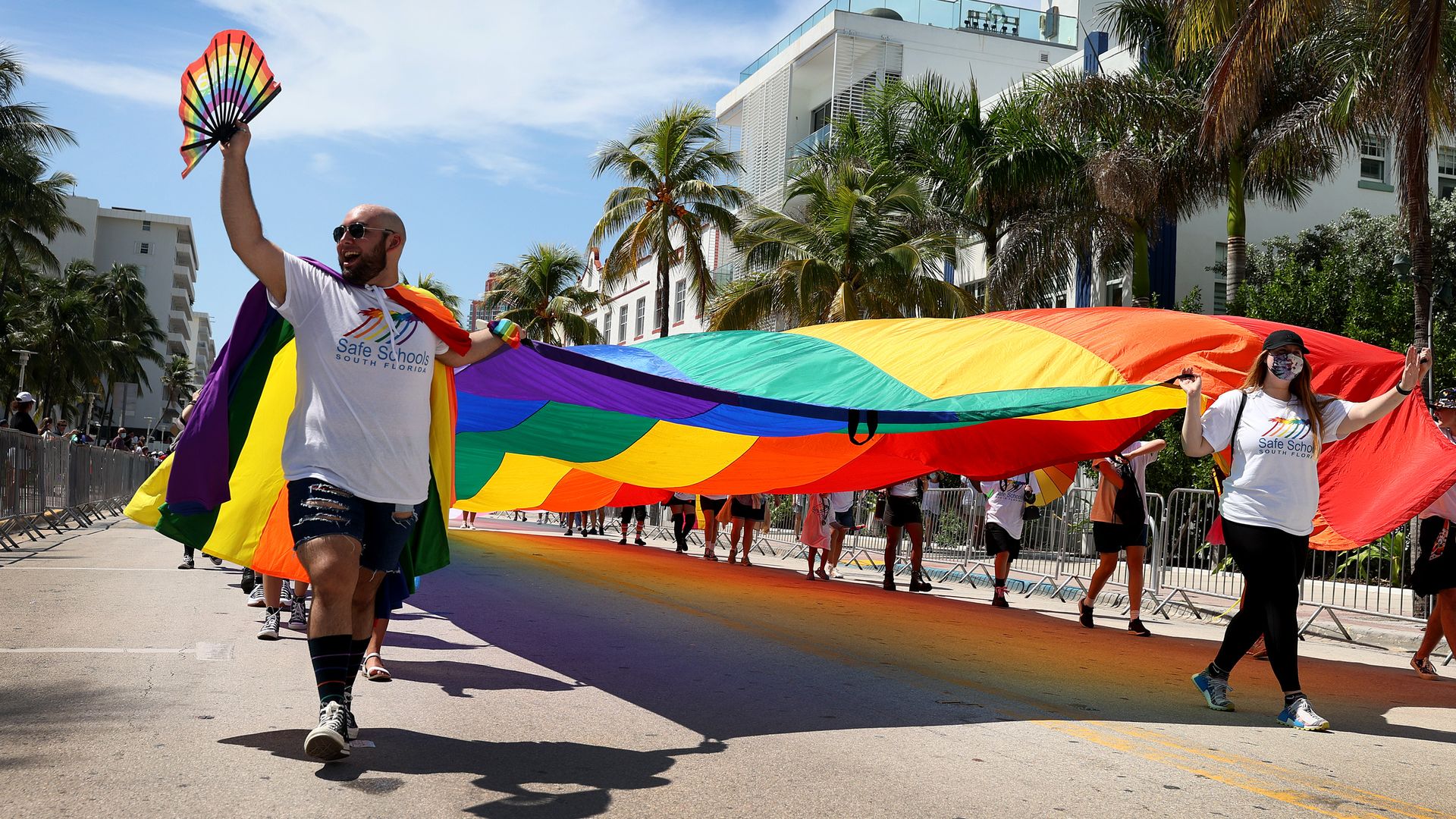 A large pride flag is carried during a parade in Miami Beach. 