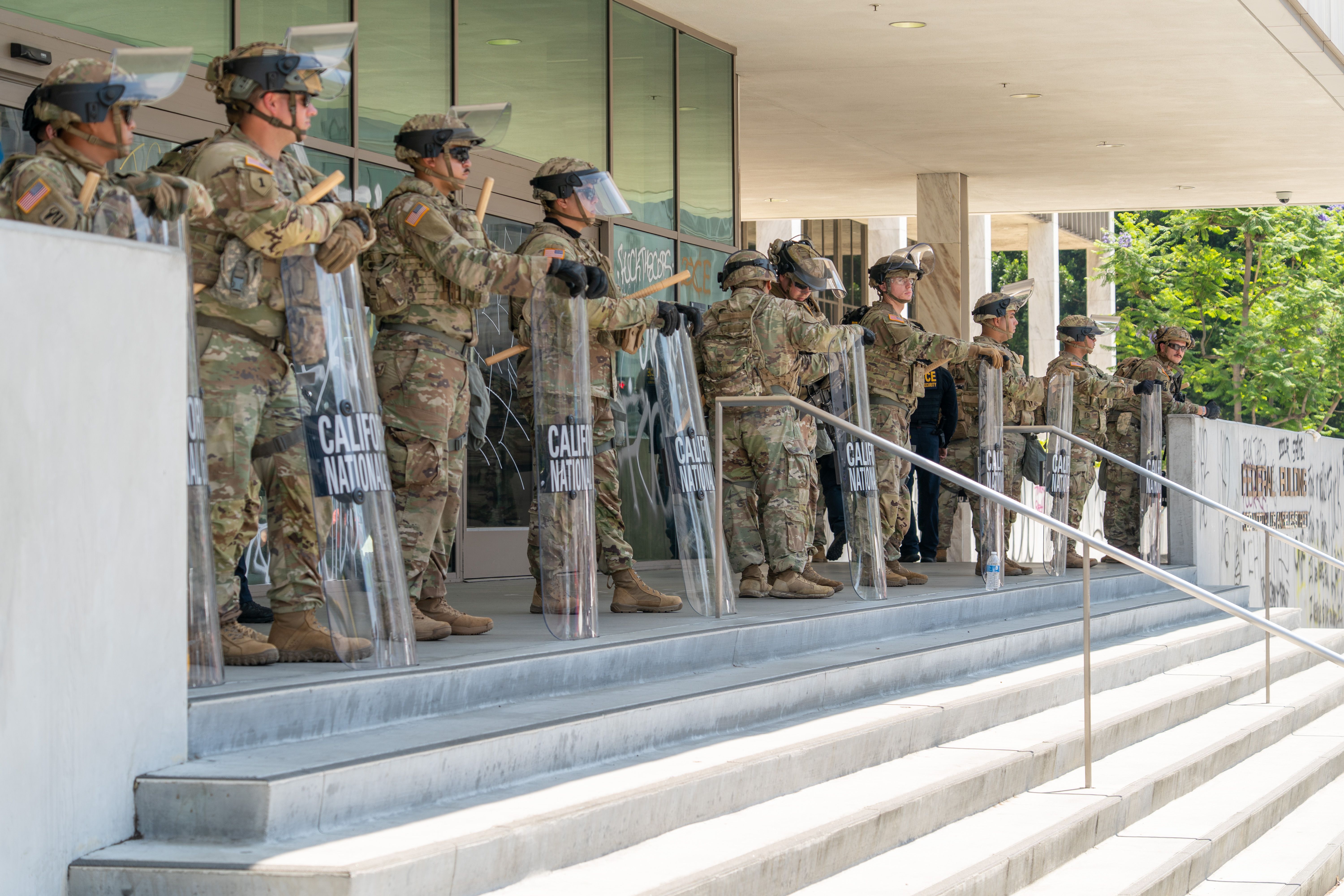 National Guard soldiers stand outside the Edward R. Roybal Federal Building in Los Angeles, California, US, on Monday, June 9, 2025. Tensions flared in Los Angeles on the third day of anti-deportation protests, as demonstrators clashed with law enforcement while President Donald Trump and California