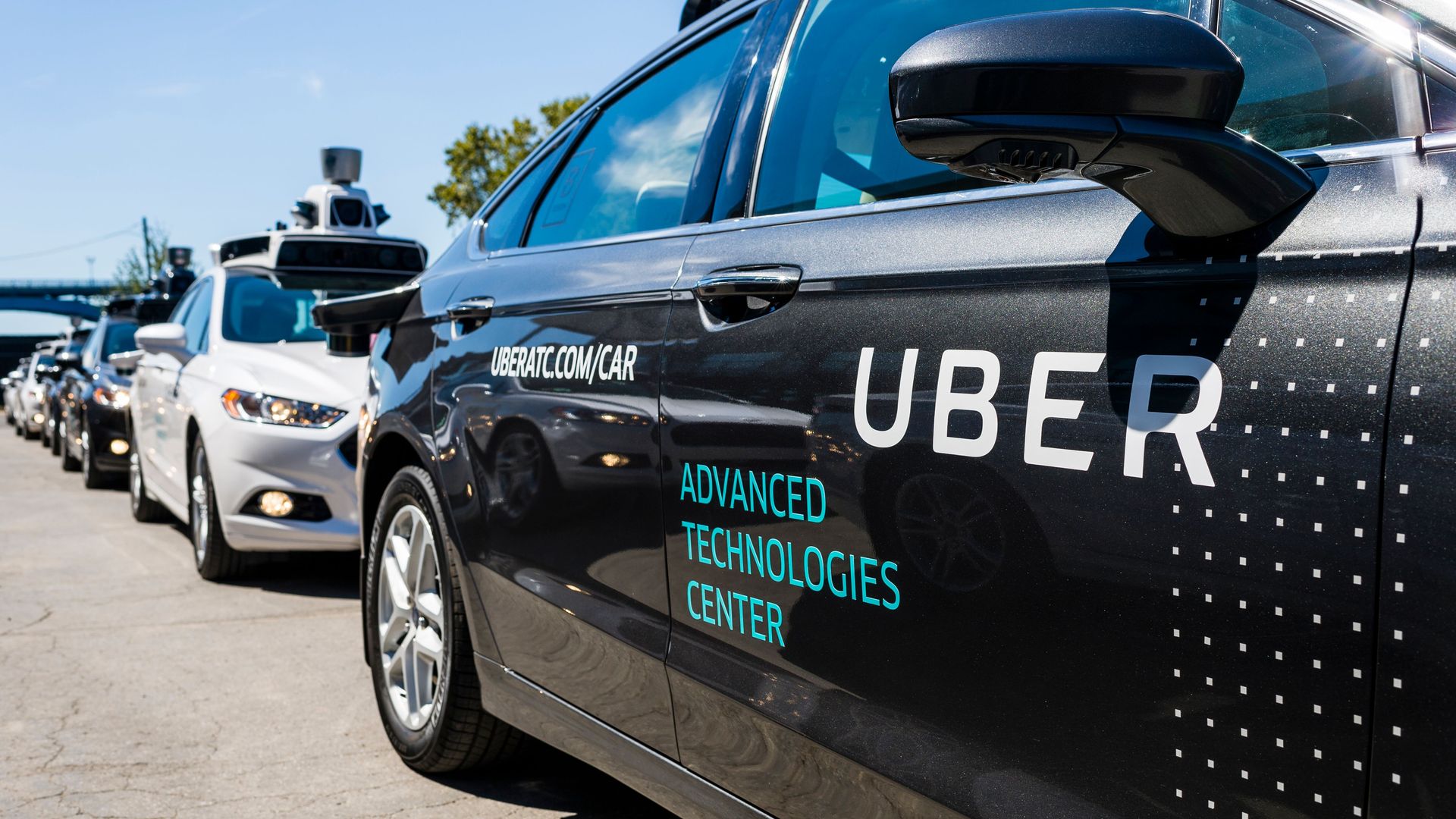Image of a line of Uber self-driving test vehicles