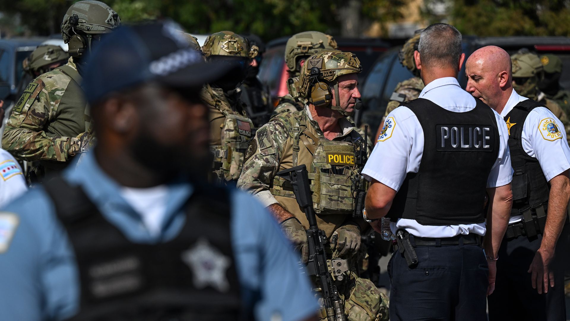 Chicago police in blue and federal agents in camouflage.