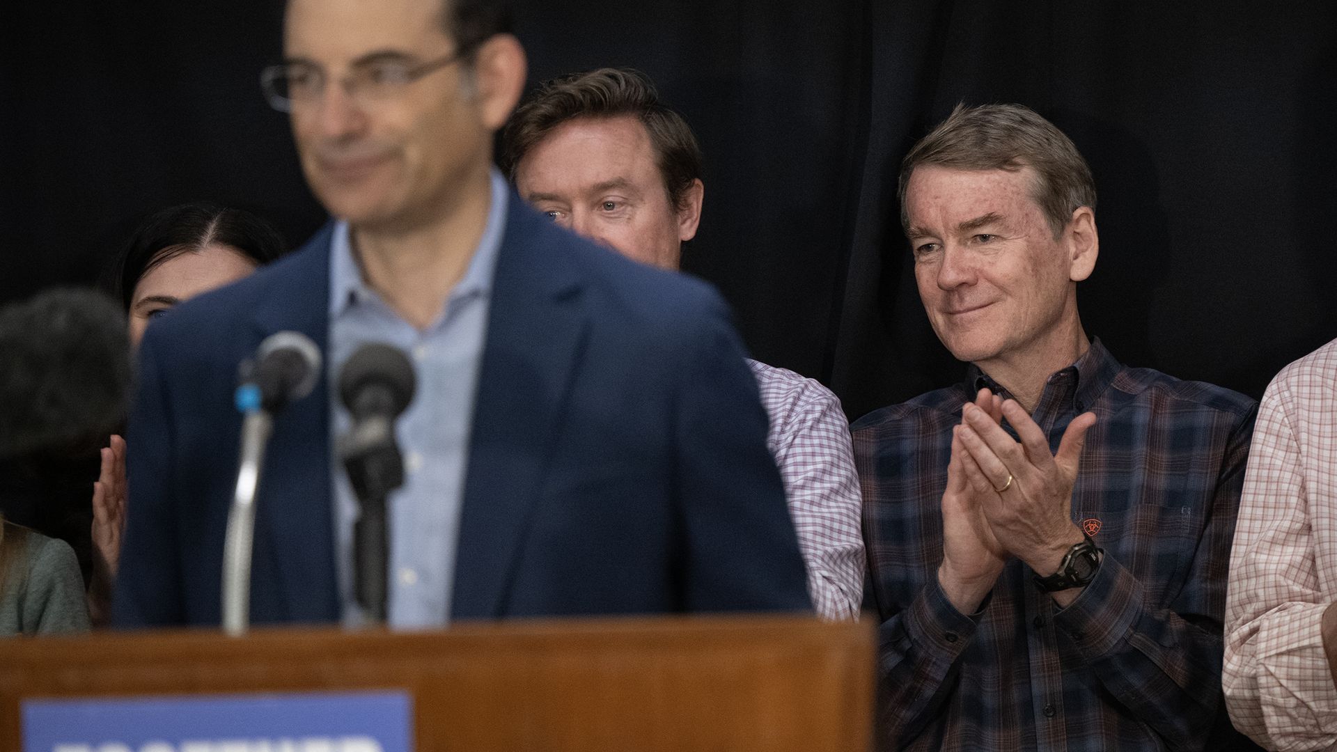 Michael Bennet looks on as Democratic gubernatorial candidate Phil Weiser speaks at an event July 2. Photo: Timothy Hurst/Denver Post via Getty Images
