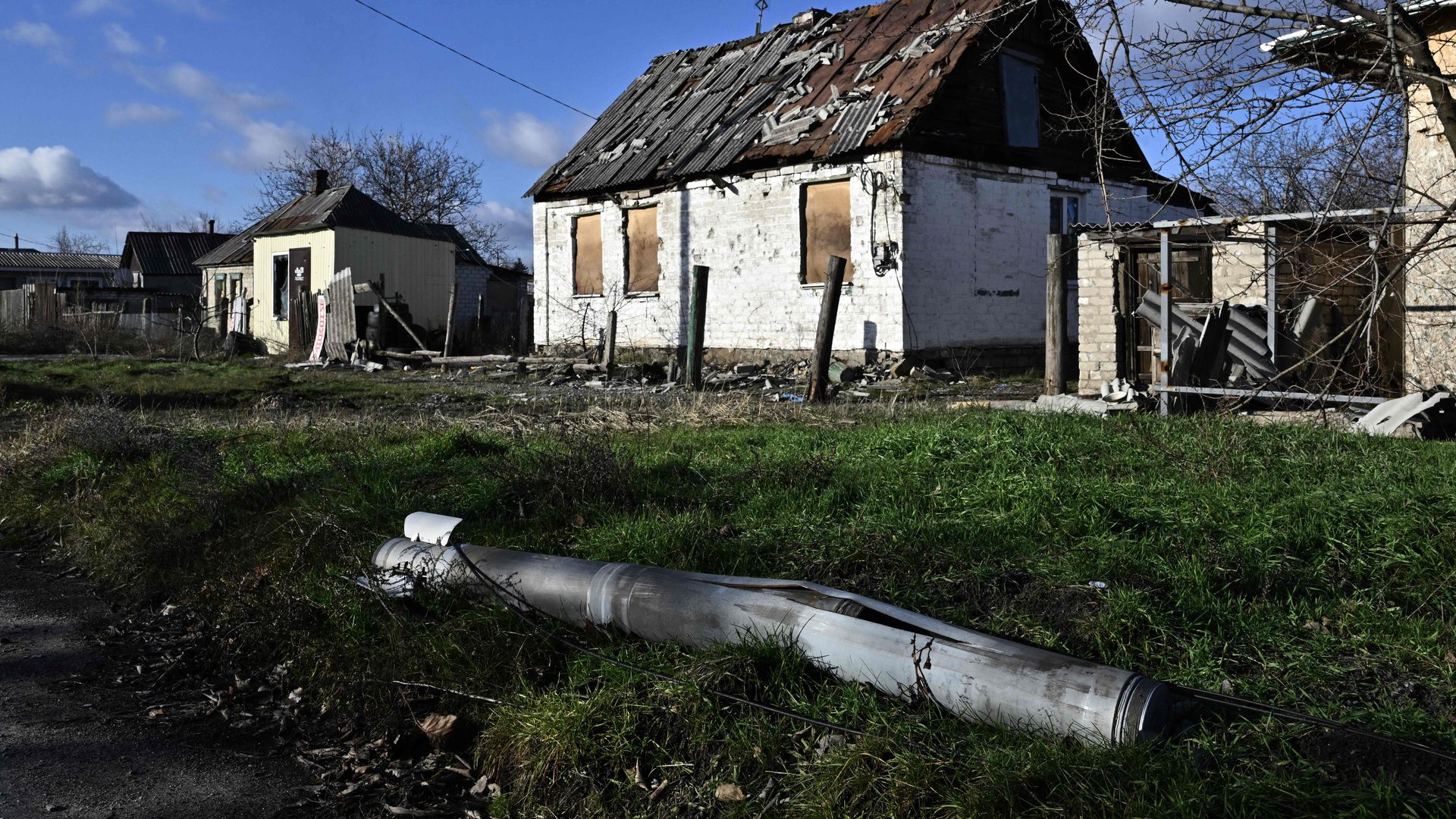 A rocket next to damaged houses in Donetsk region