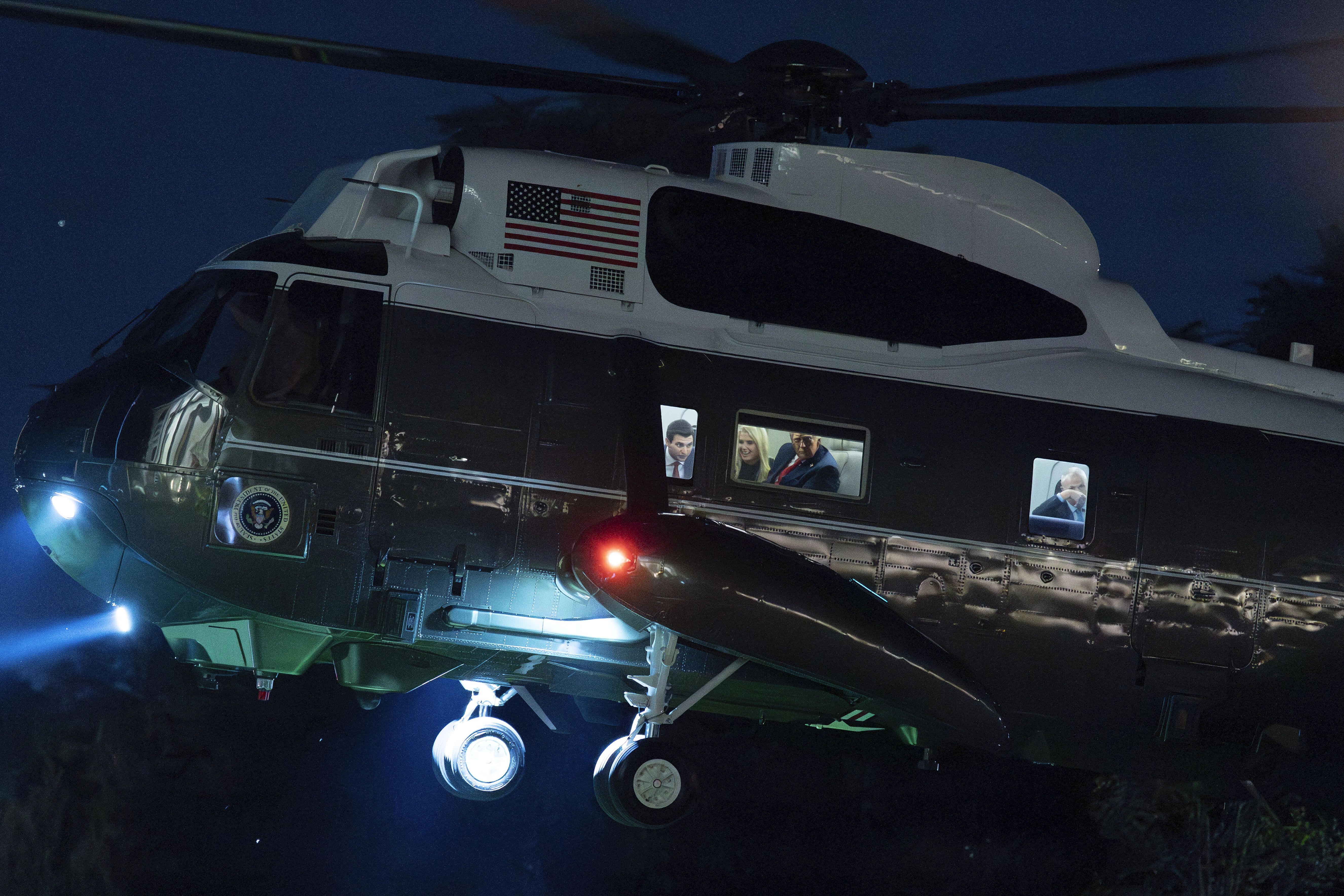 President Trump looks through the window of Marine One last night upon his return to the White House after a state visit to the U.K.