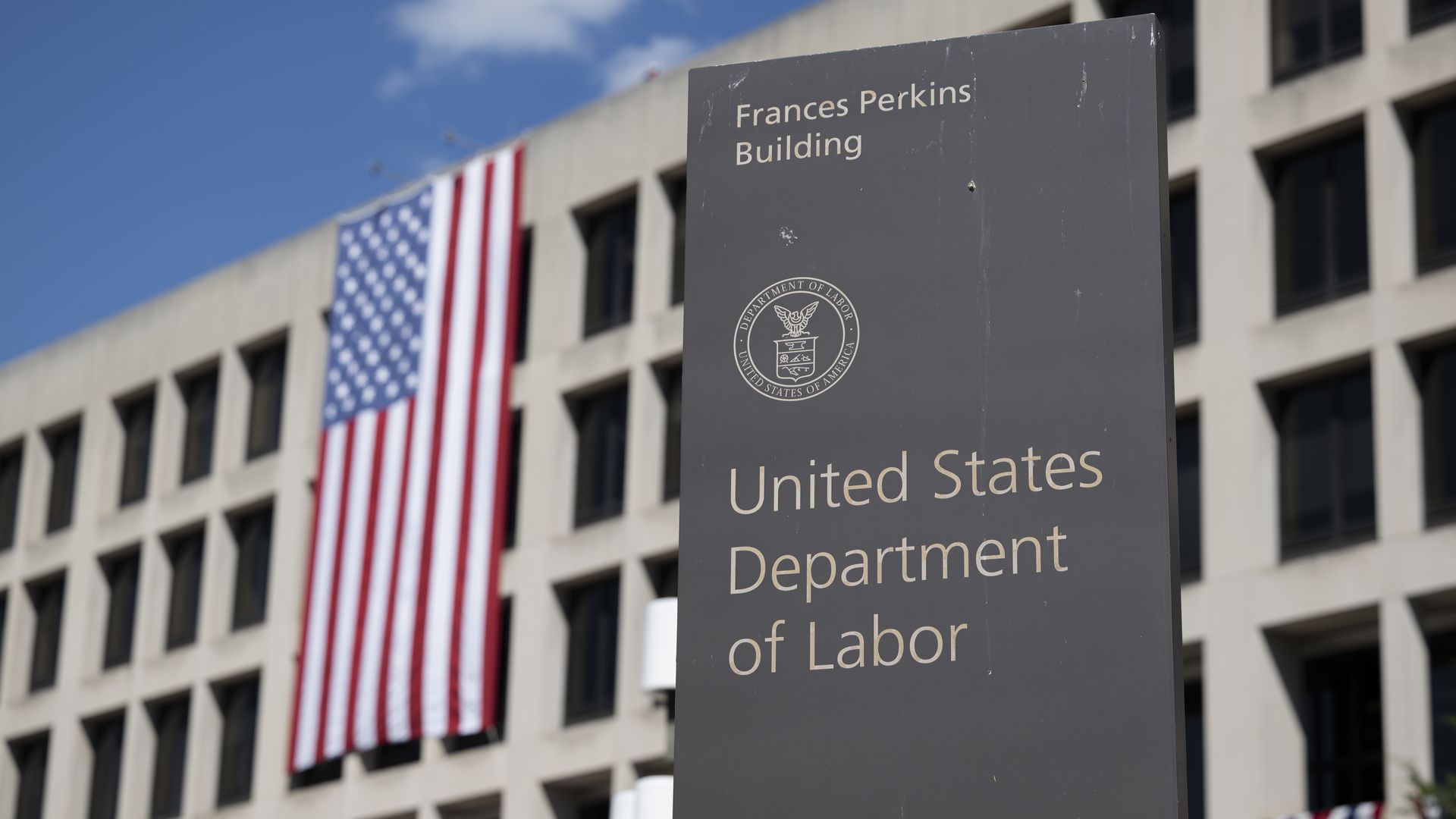 A large US flag is seen on the facade of the Department of Labor headquarters building in Washington DC, United States on September 8, 2025.