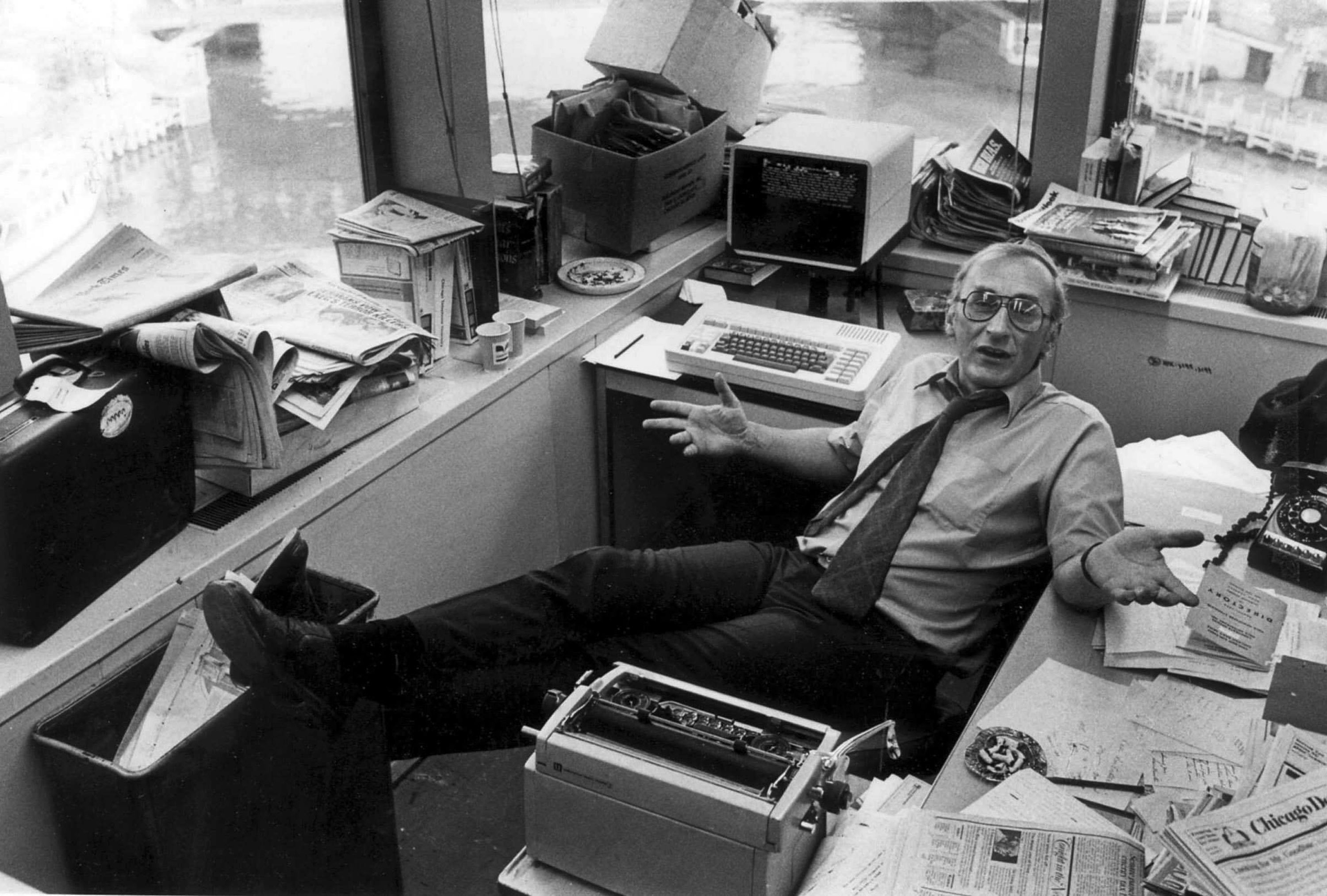 Photo of a man sitting with his feet up at an office desk 