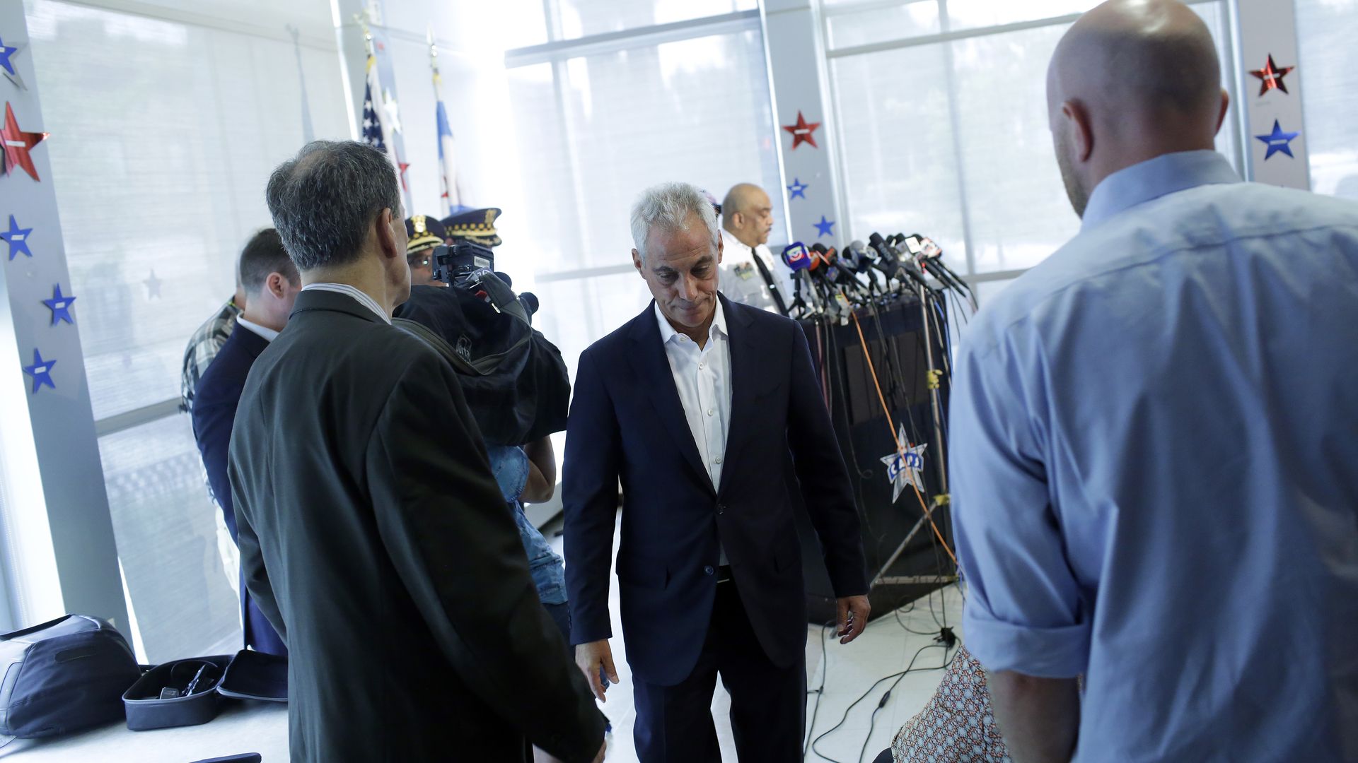 Rahm Emanuel with his head down.