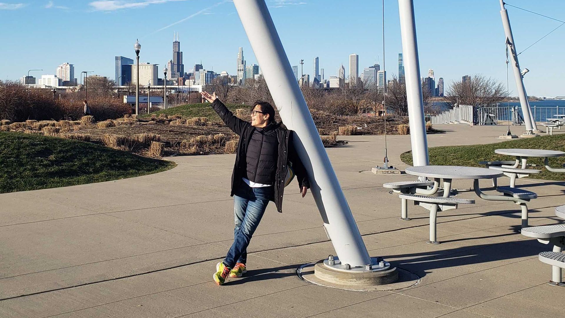 Woman standing in front of a big blue sky and skyline. 