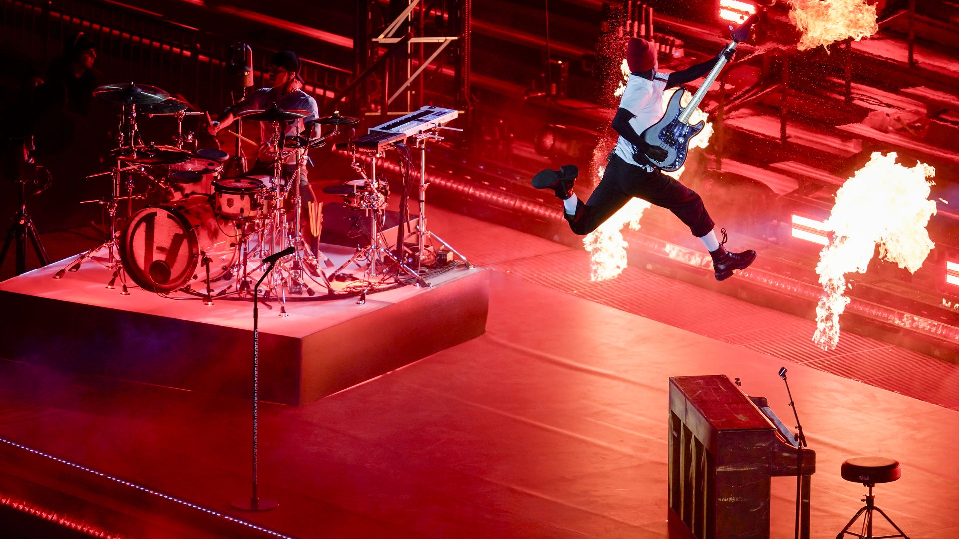 Twenty One Pilots plays on stage at Ohio Stadium as flames fly into the air