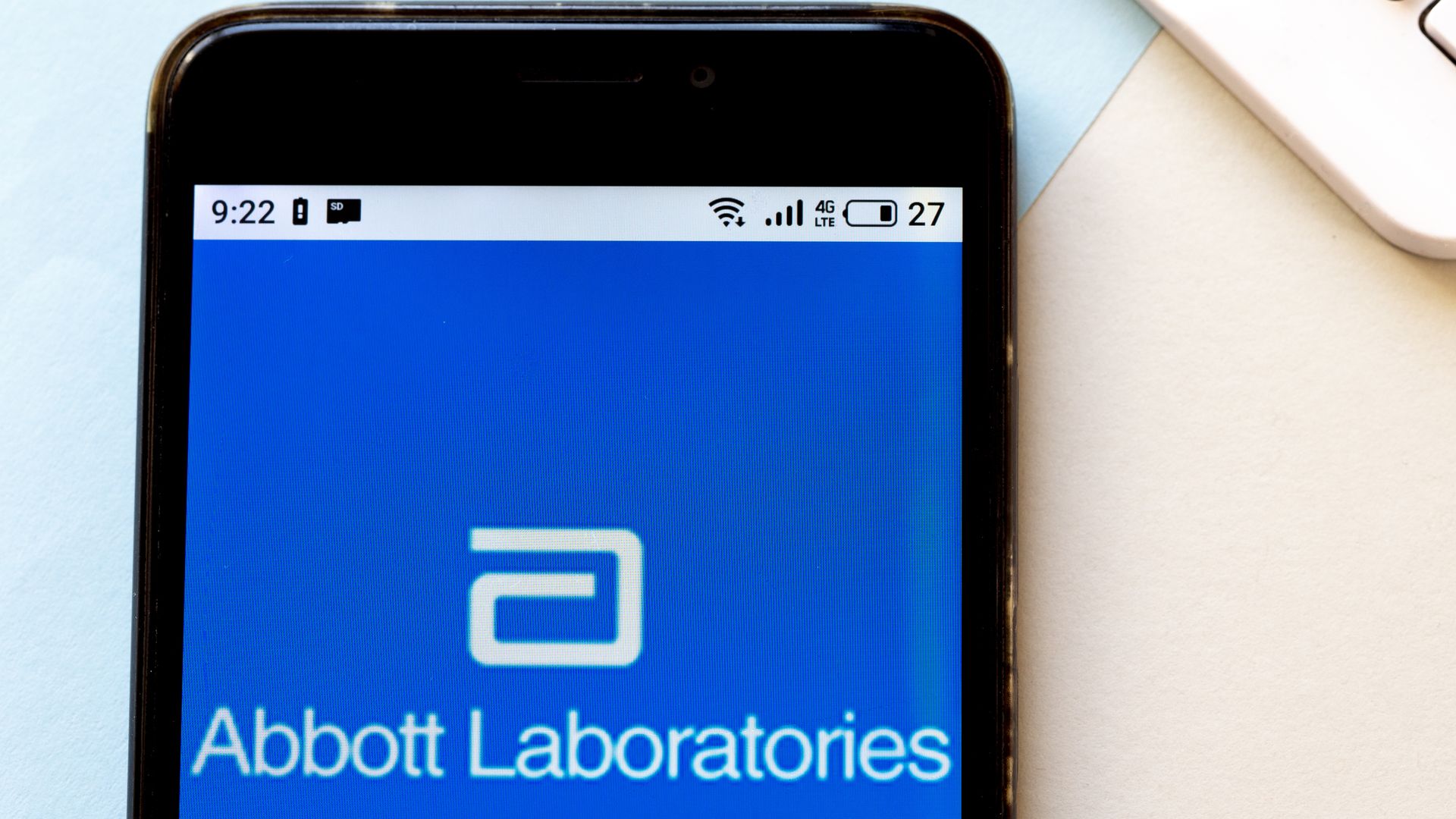 In this image, a phone screen says the phrase "Abbott Laboratories" 