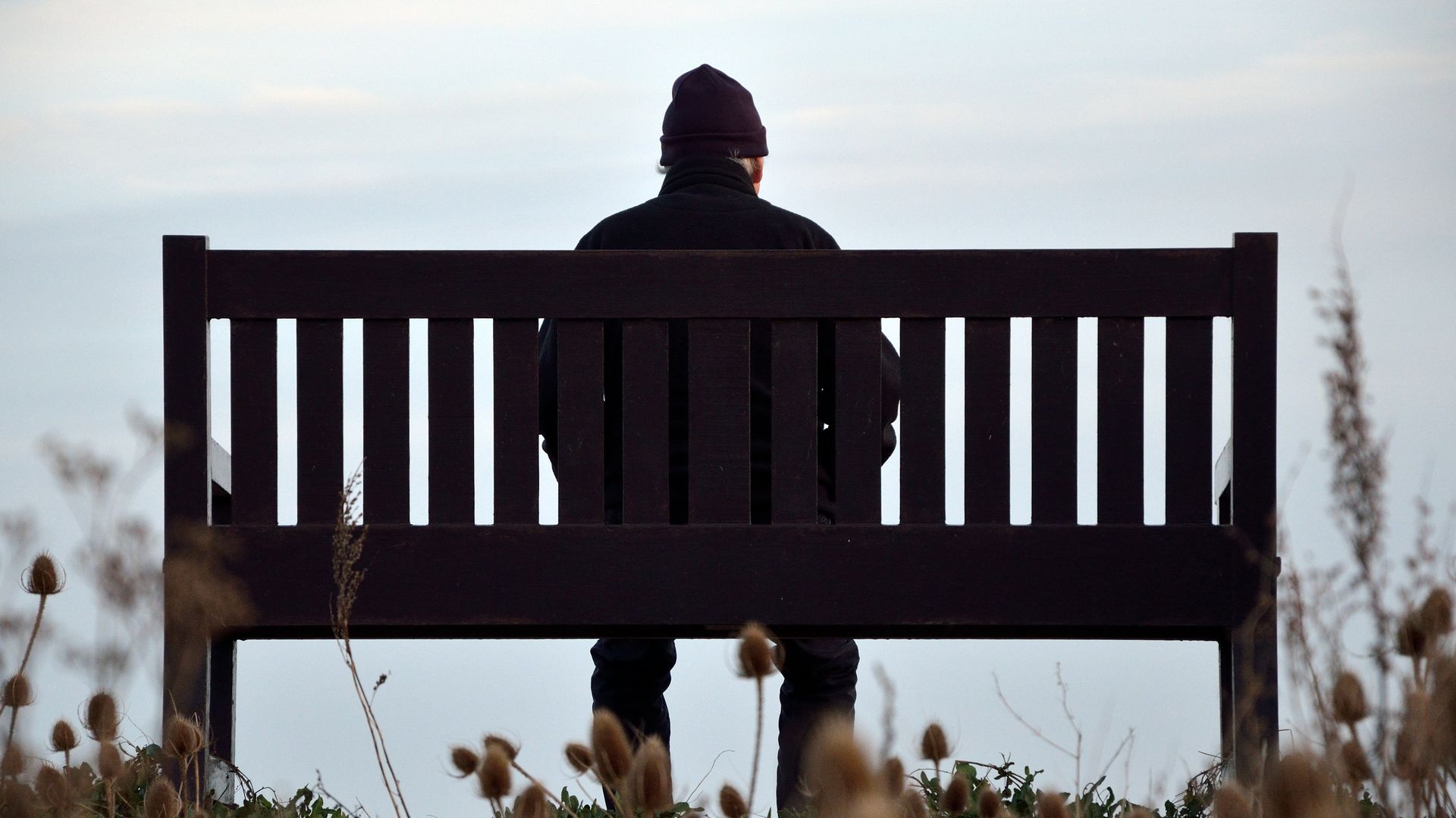 A man sits on a park bench