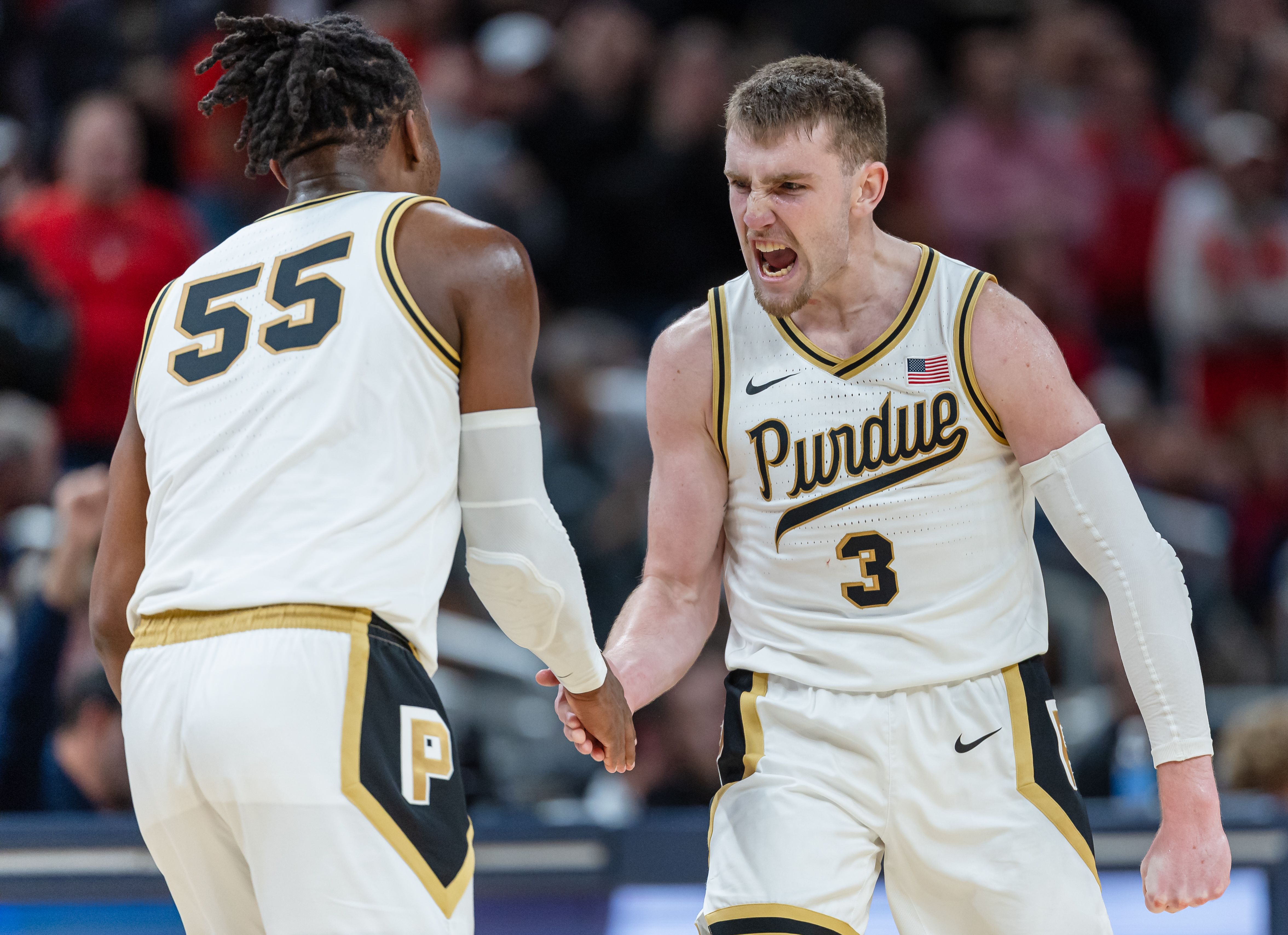Lance Jones and Braden Smith of the Purdue Boilermakers celebrate during the second half against the Arizona Wildcats in the Indy Classic at Gainbridge Fieldhouse.