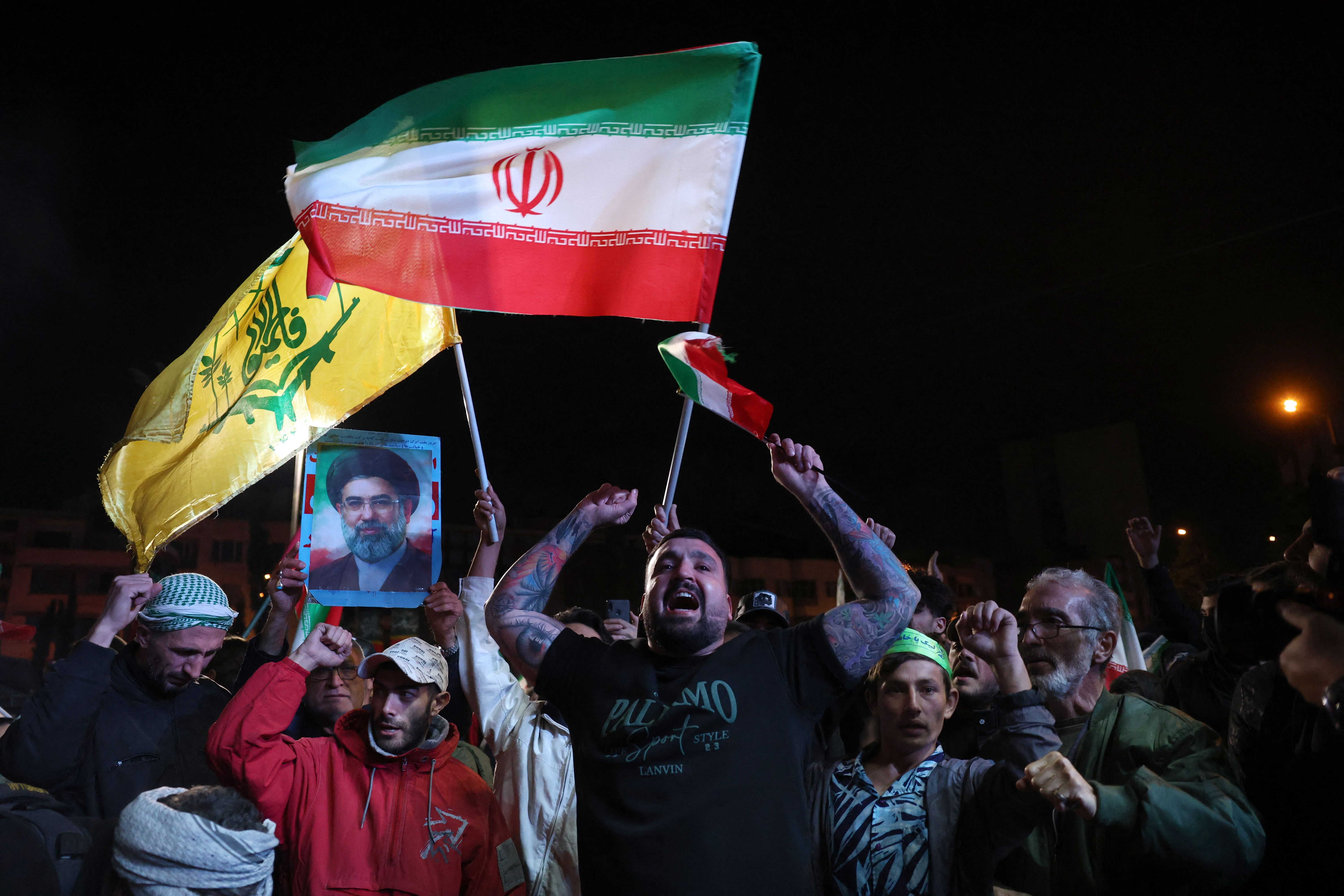 TOPSHOT - Iranians react after a ceasefire announcement at the Enqelab square, in Tehran, on April 8 2026. The United States and Iran agreed to a two-week ceasefire Tuesday barely an hour before US President Donald Trump's deadline to obliterate the rival country was set to expire, with Tehran to te