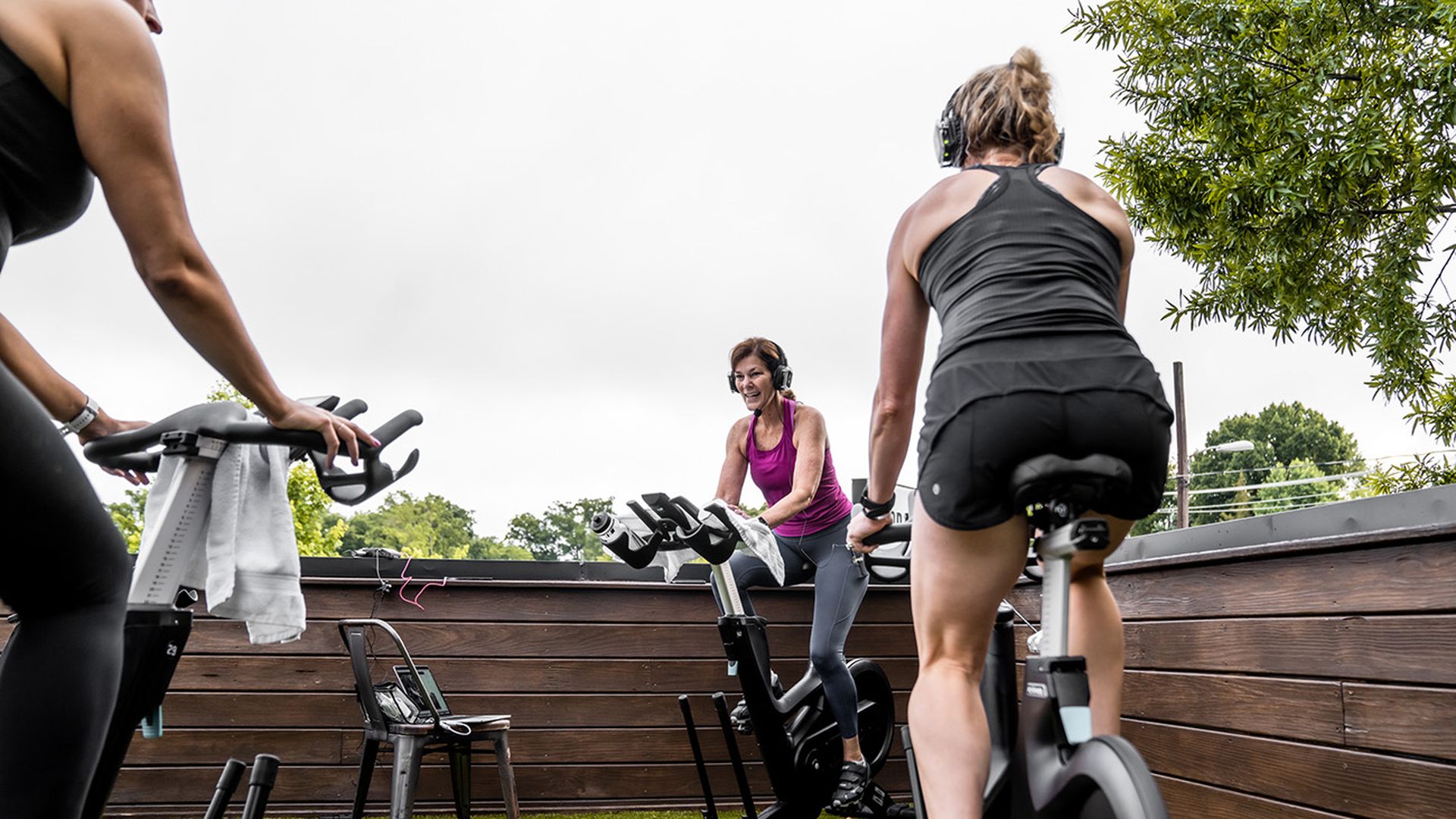 people exercising on bikes on rooftop