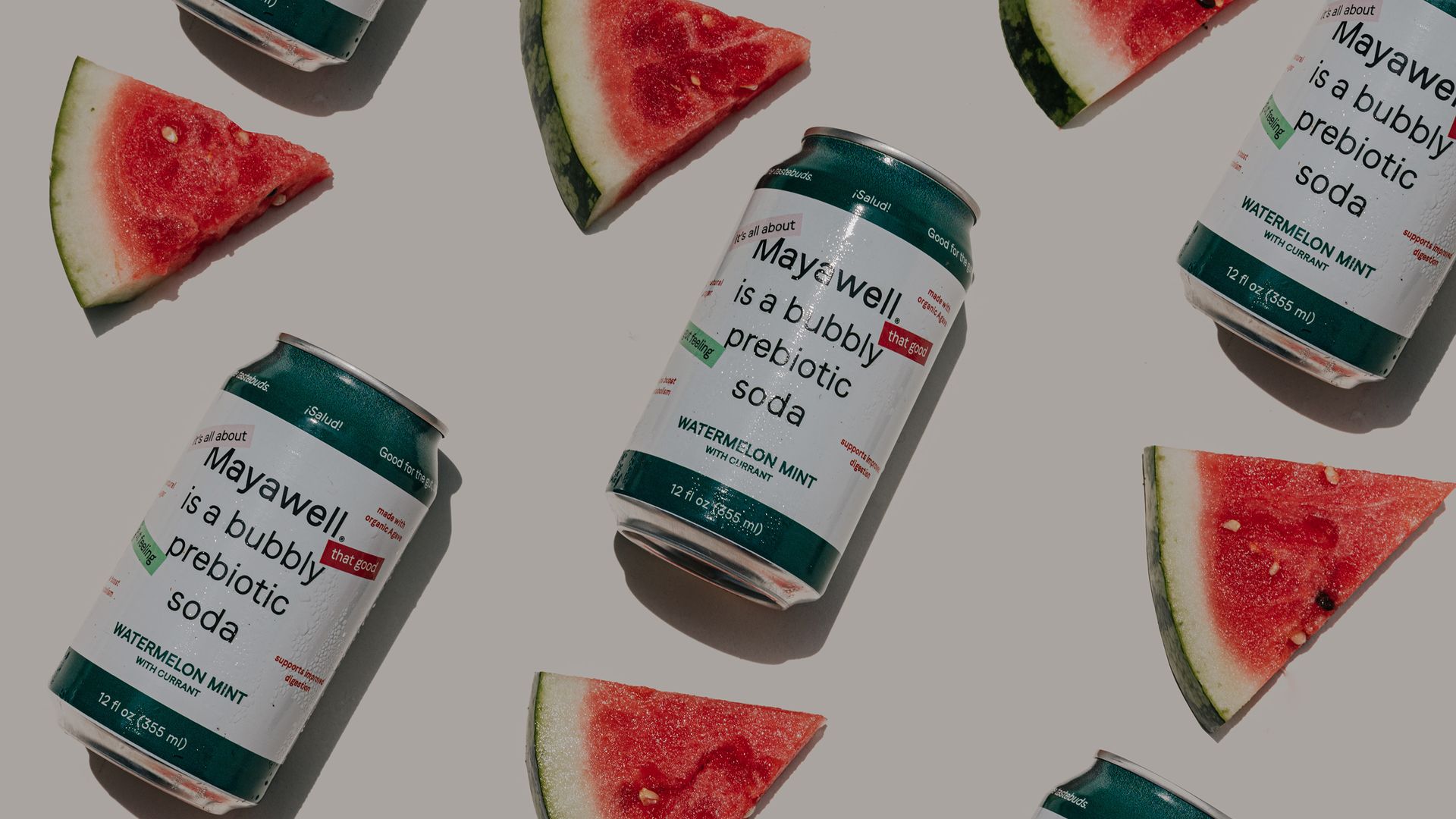 Sliced watermelon interspersed with white and green aluminums cans containing a prebiotic carbonated beverage from Mayawell.