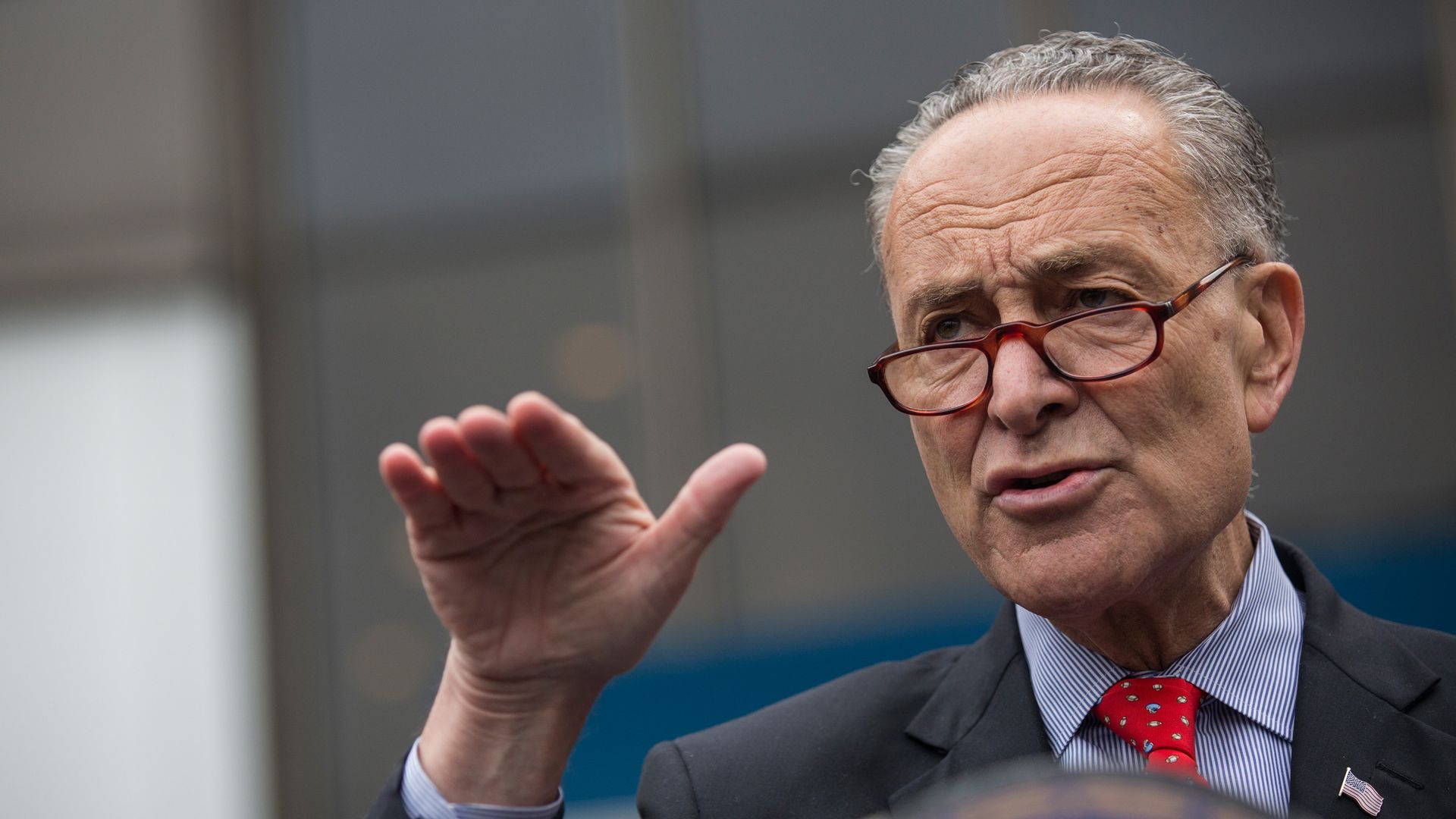 Chuck Schumer speaking with his hand up