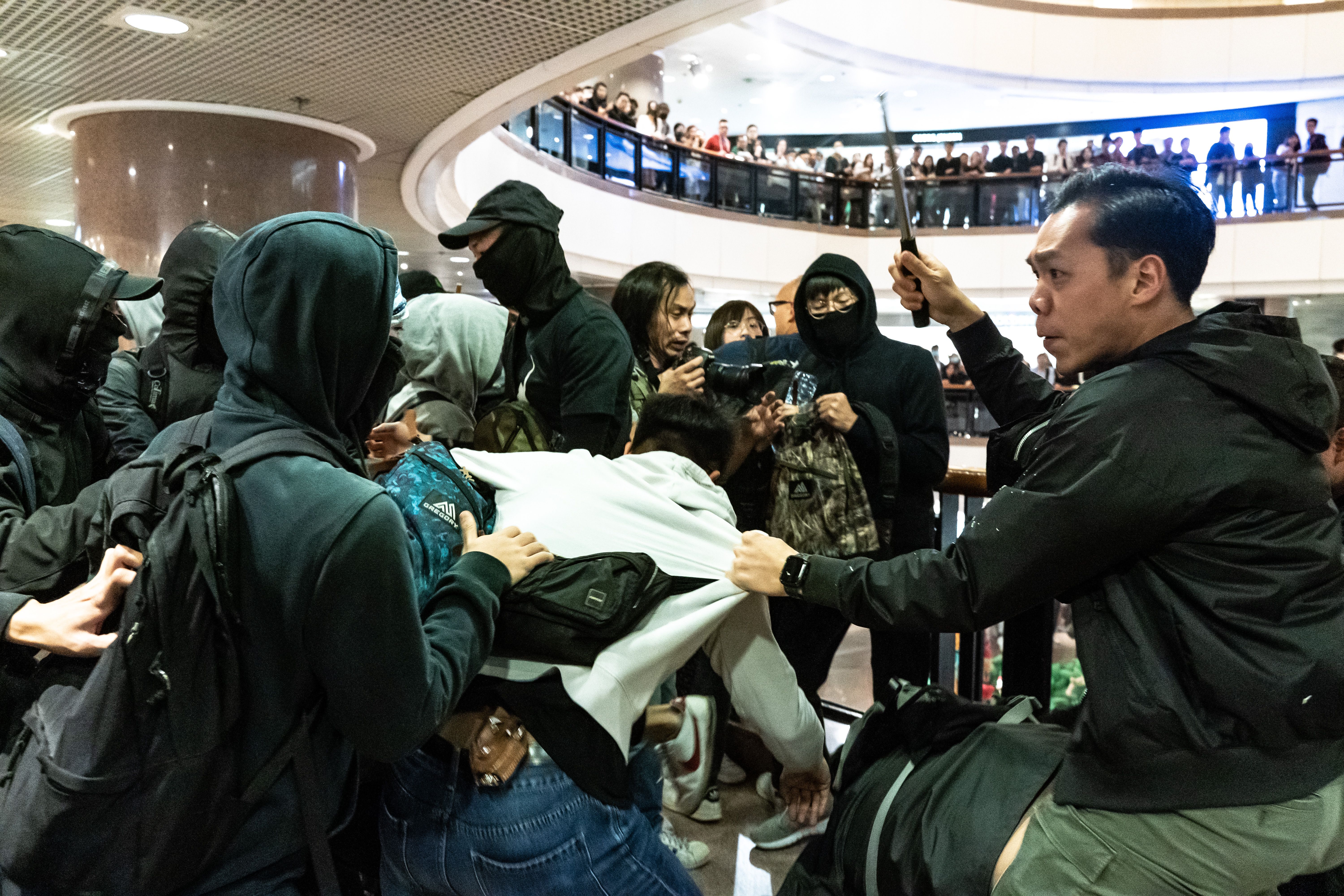 Plain clothes police react during a clash with protesters in a shopping mall on December 24, 2019 in Hong Kong