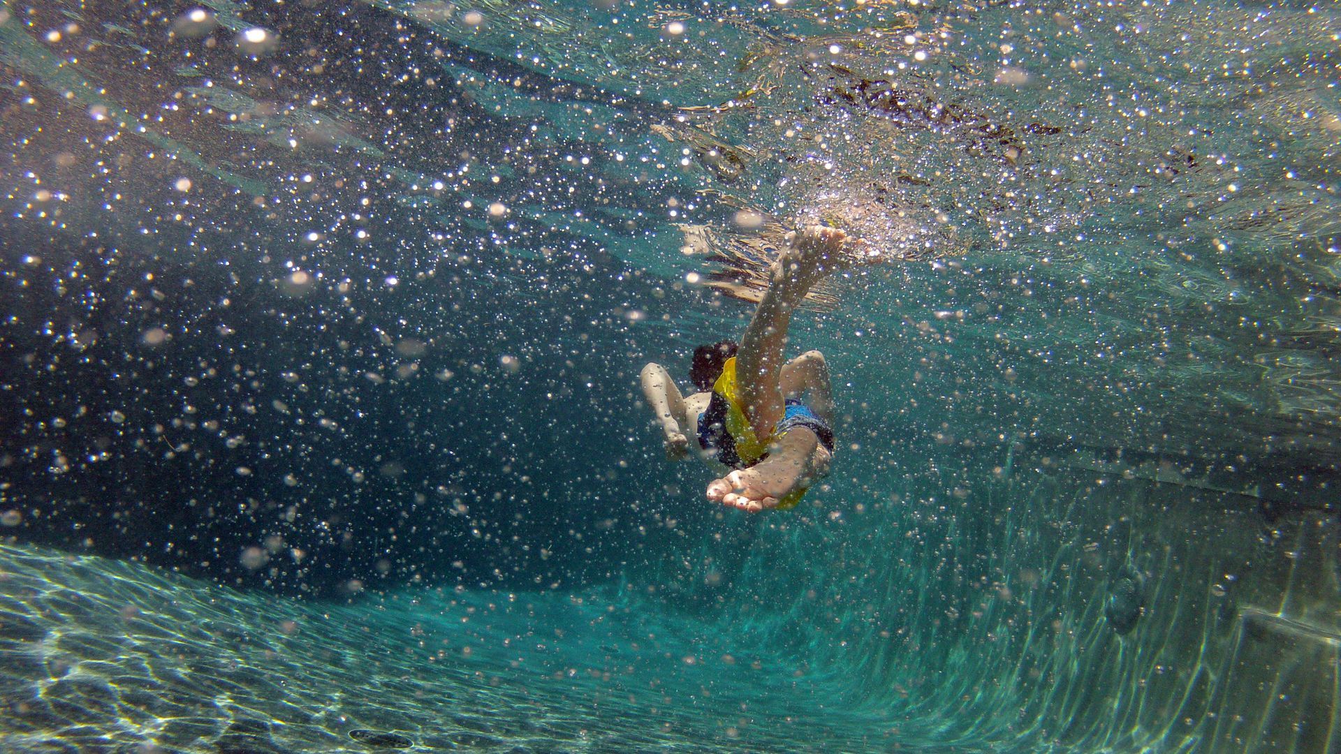 A child swims through a pool