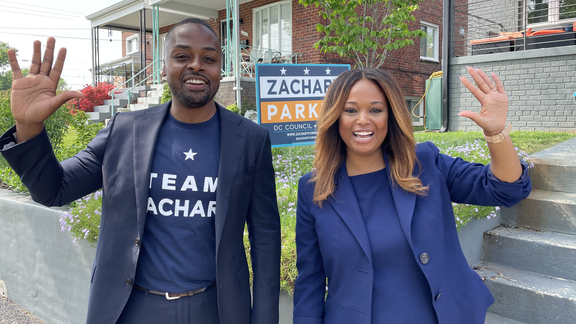 Zachary Parker (left) and Ward 4 Council member Janeese Lewis George stand side by side on a street of rowhouses