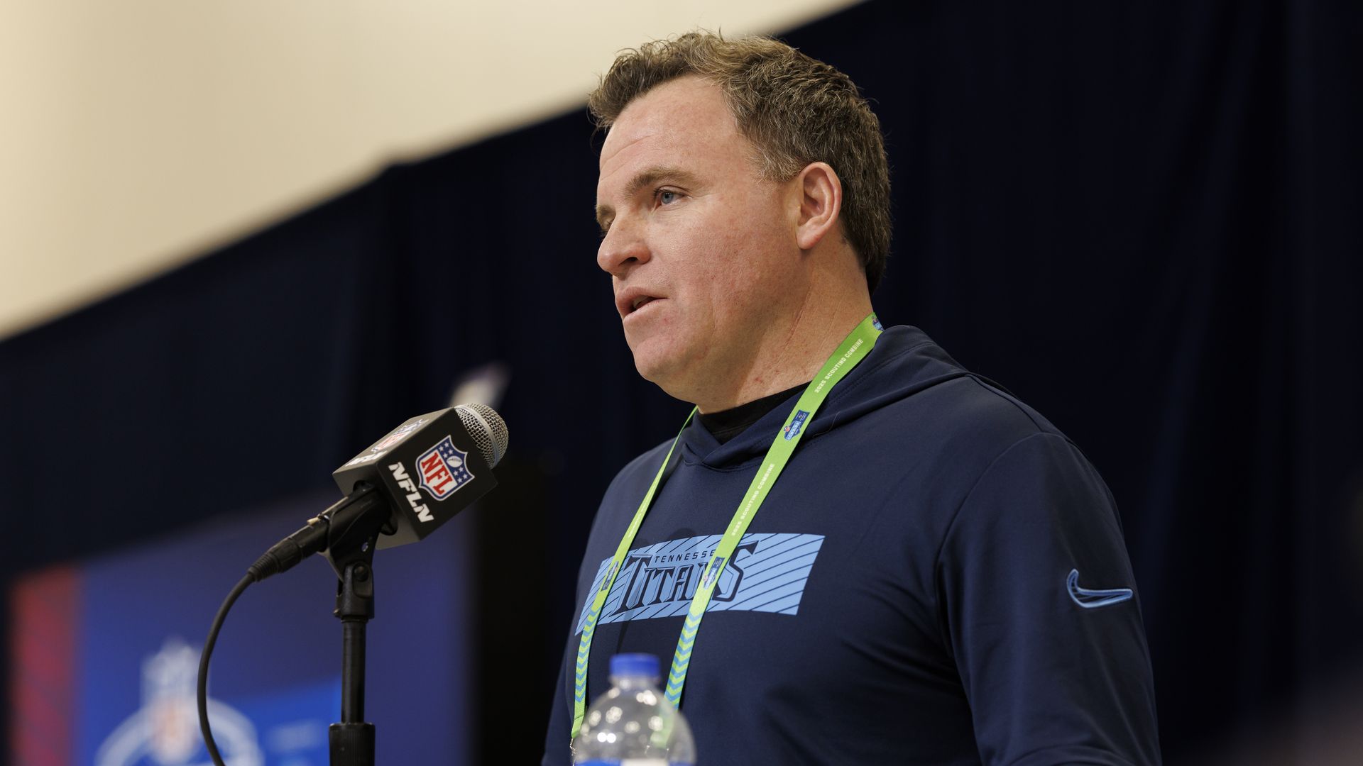 Titans GM Mike Borgonzi speaks at a podium during a press event earlier this year.
