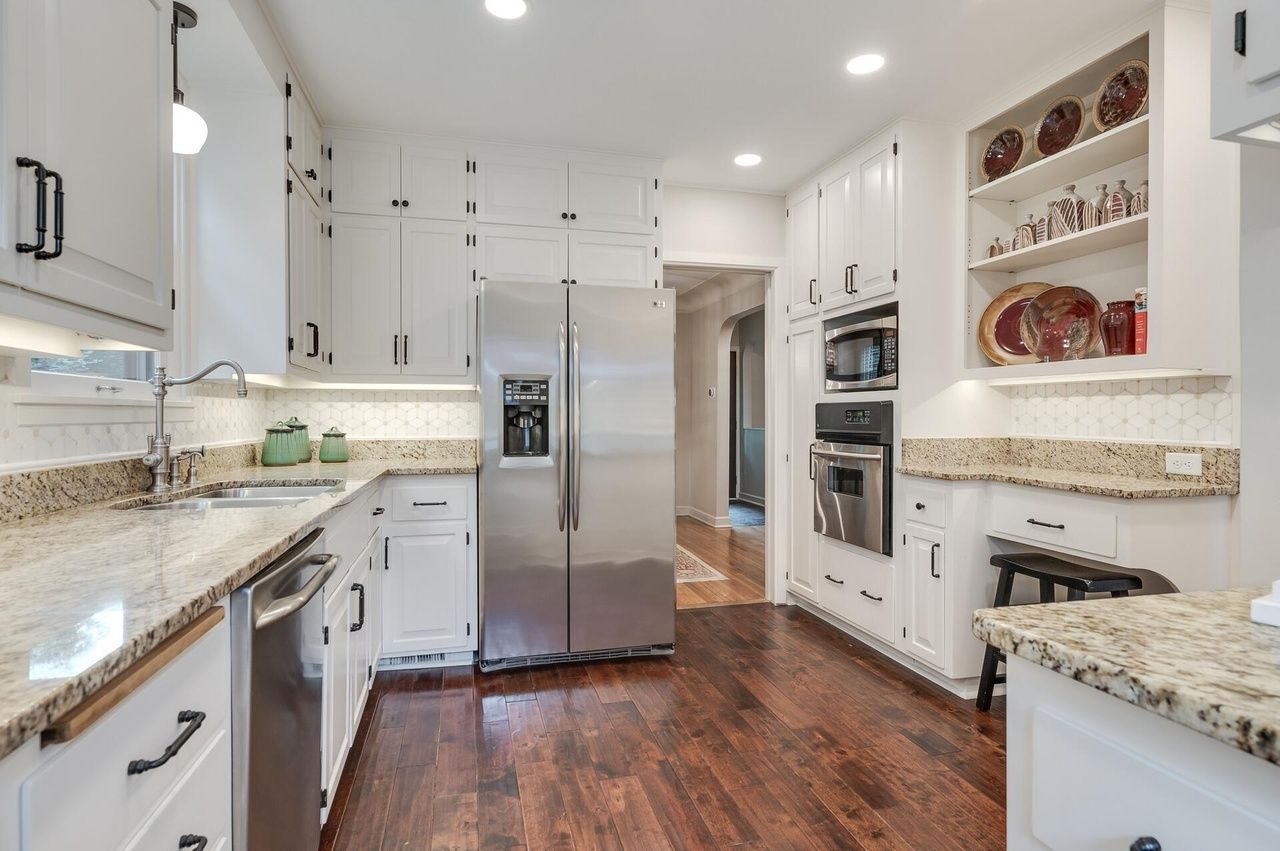large kitchen with white cabinets and built ins