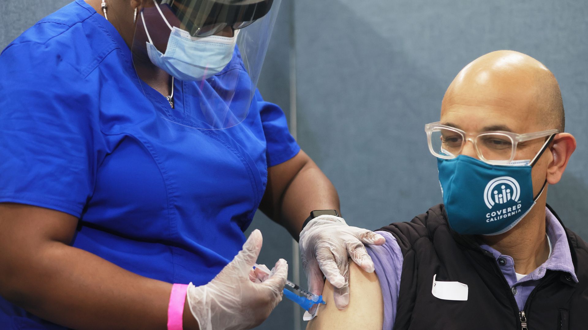 A health care worker administers a shot of the Johnson & Johnson coronavirus vaccine