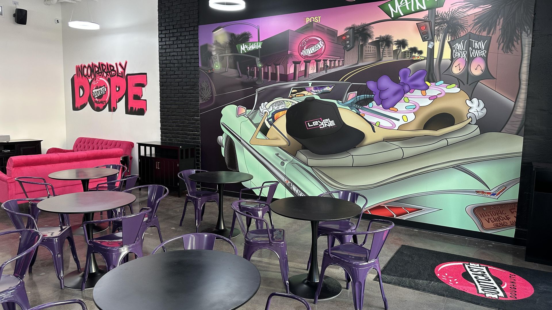 A mural with two doughnuts in a convertible.