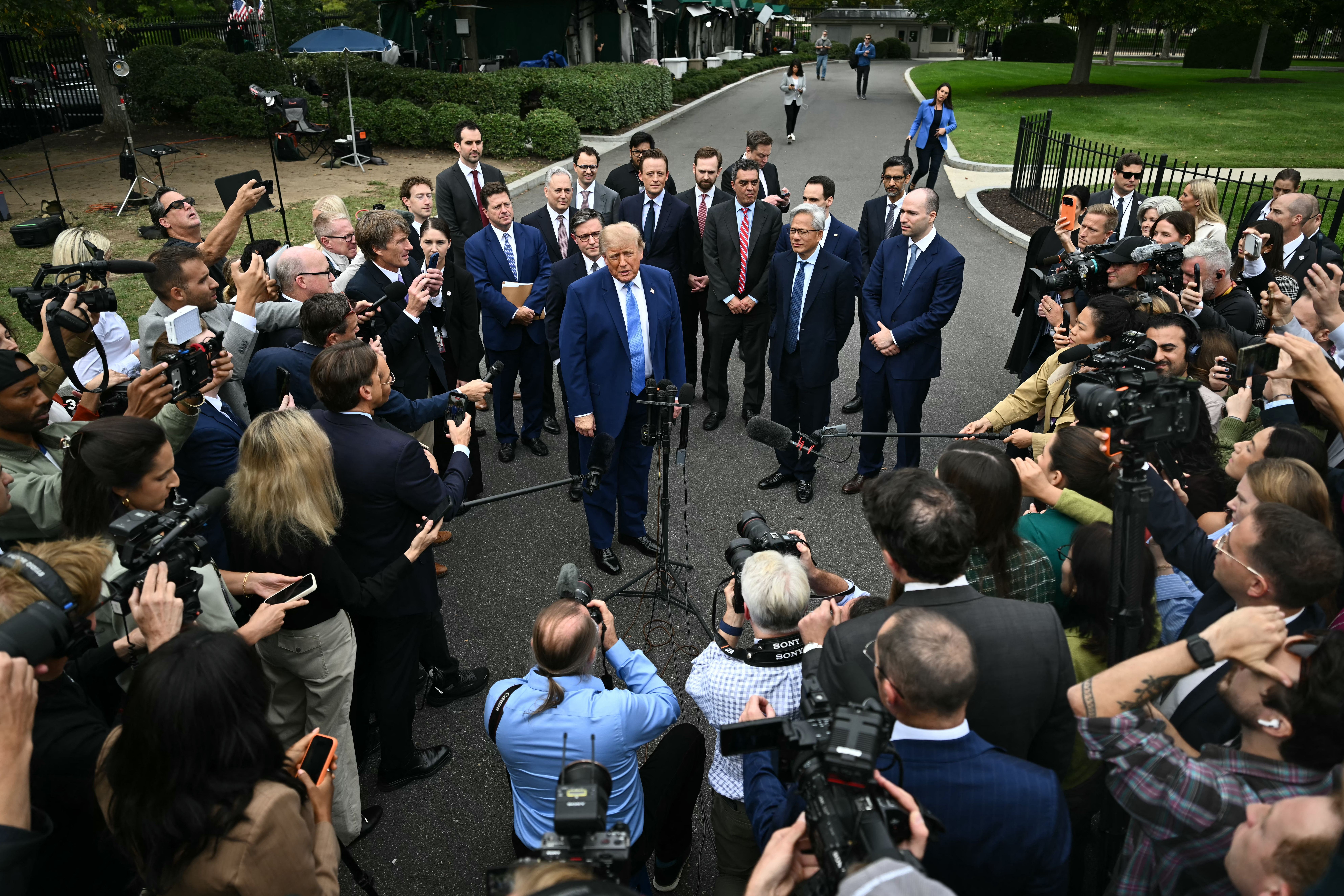 President Trump and tech titans talk to reporters in the West Wing driveway
