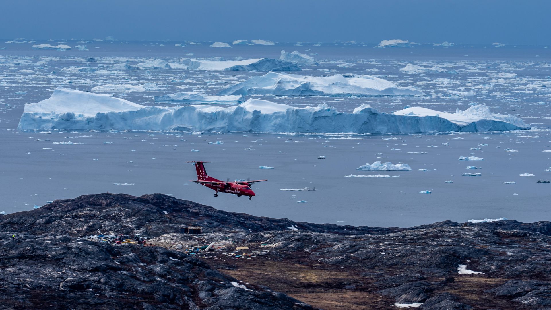 An airplane flys over Greenland