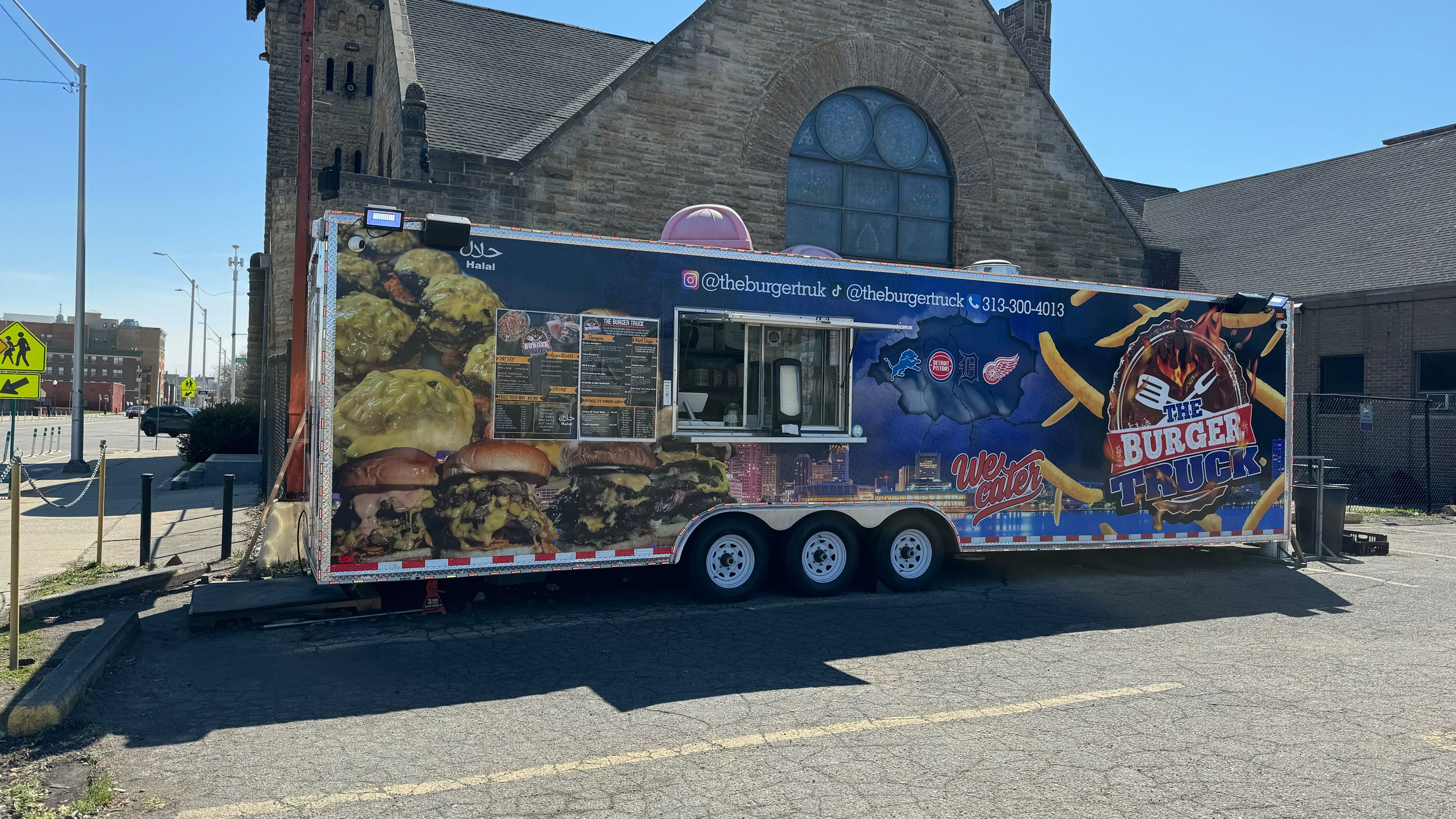 A side view of the food truck parked in its lot. 