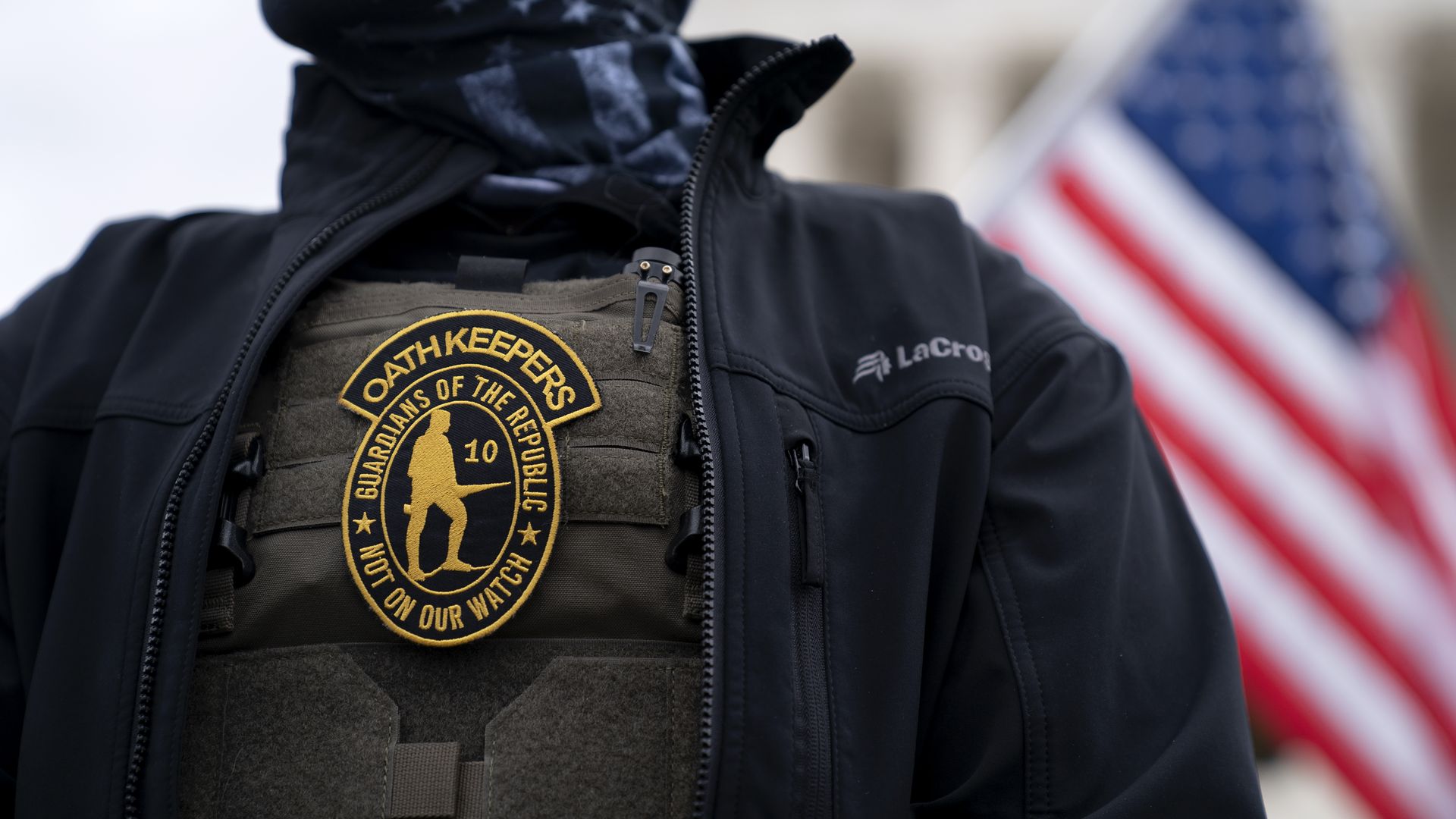 A person wearing an Oath Keepers badge on a protective vest outside of the Supreme Court on Jan. 5, 2021.