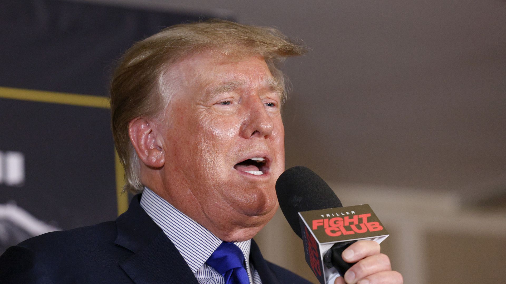 Photo of Donald Trump speaking into a mic