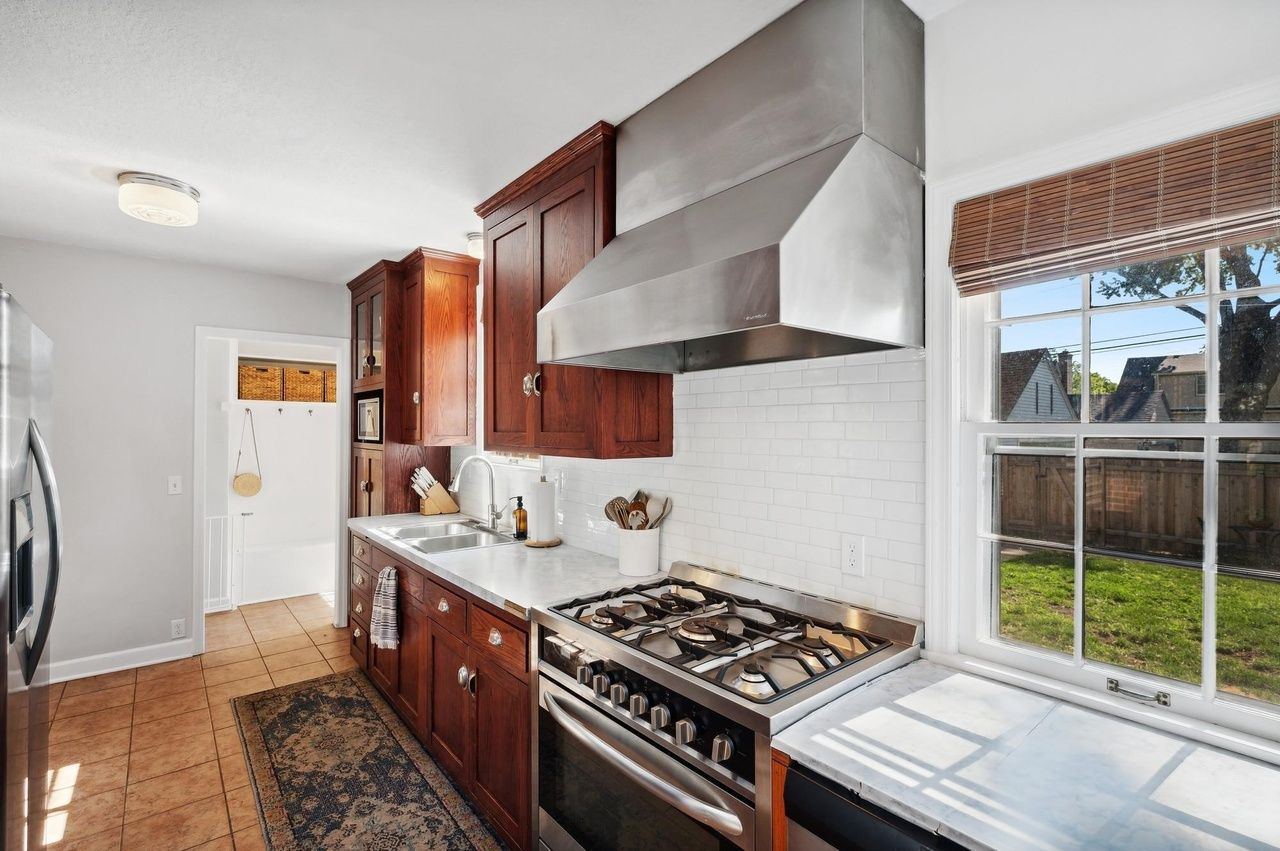 kitchen with modern appliances and wood cabinetry