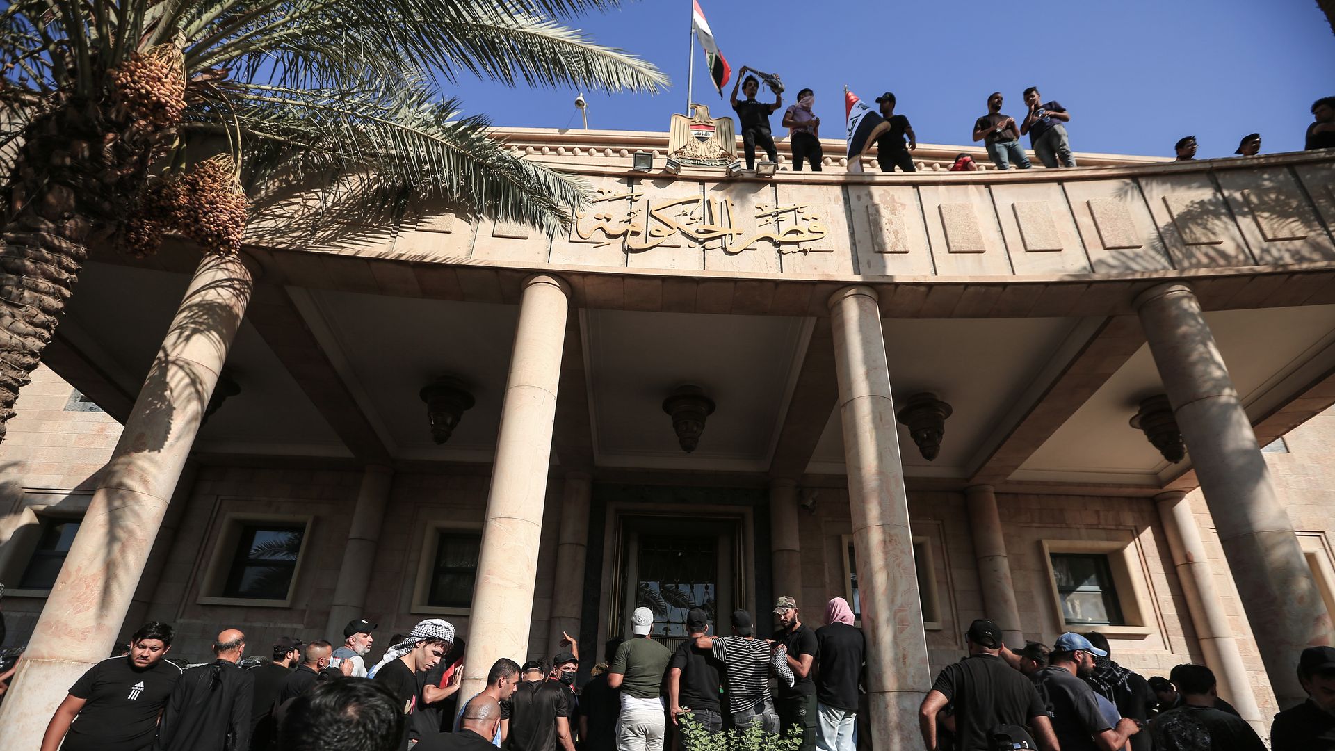 Supporters of Shiite cleric Muqtada Al-Sadr enter the Government Palace during a protest.