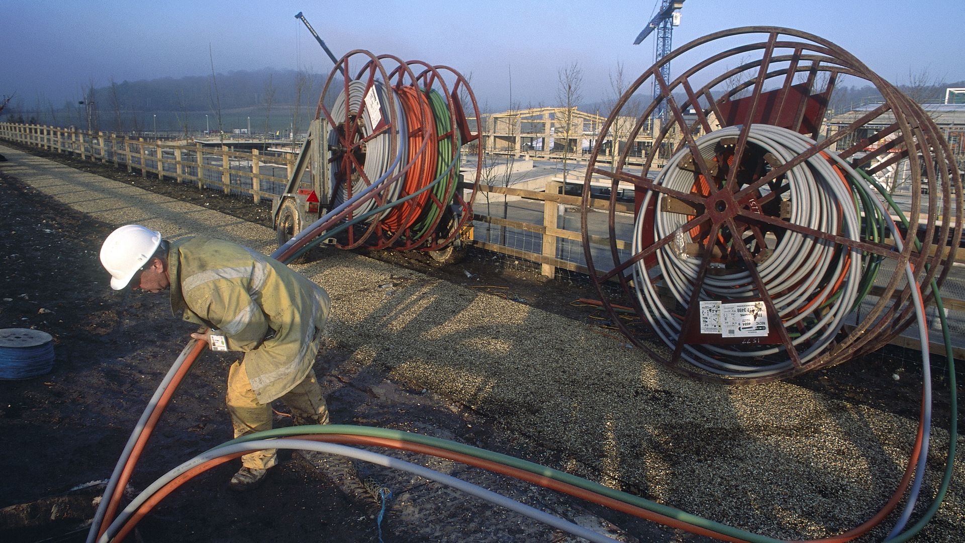 a worker installing fiber optic cables
