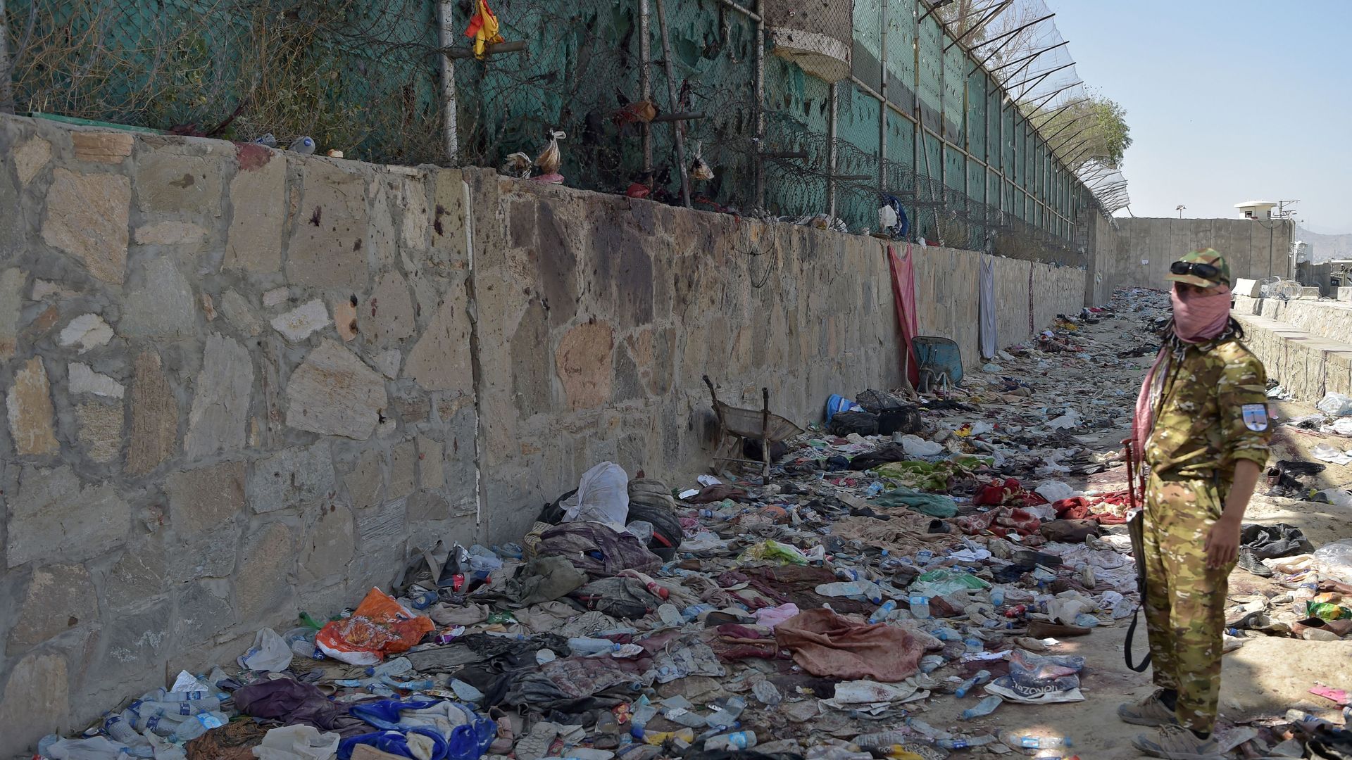 A Taliban fighter stands guard at the site of the August 26 twin suicide bombs, which killed scores of people including 13 US troops, at Kabul airport on August 27, 2021.