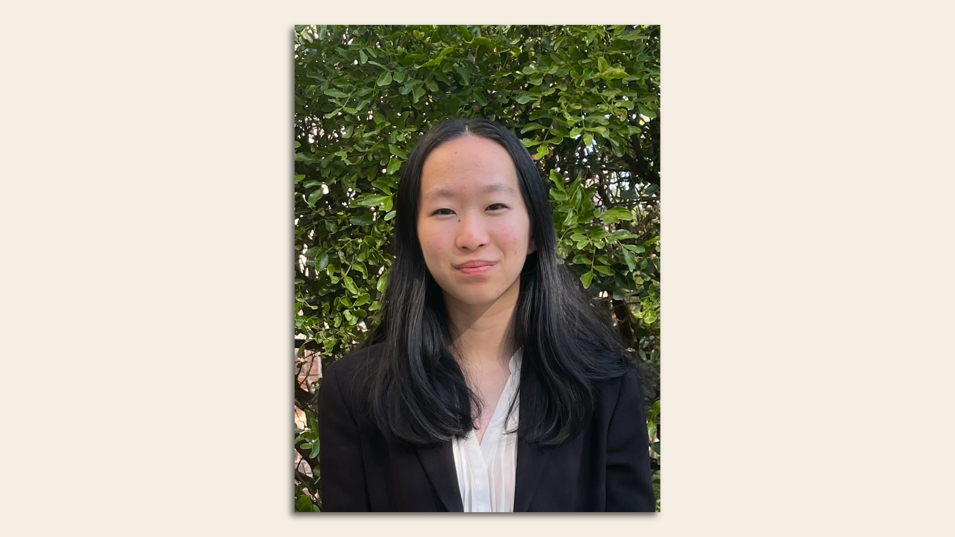 Hannah Guan in front of a greenery background. 