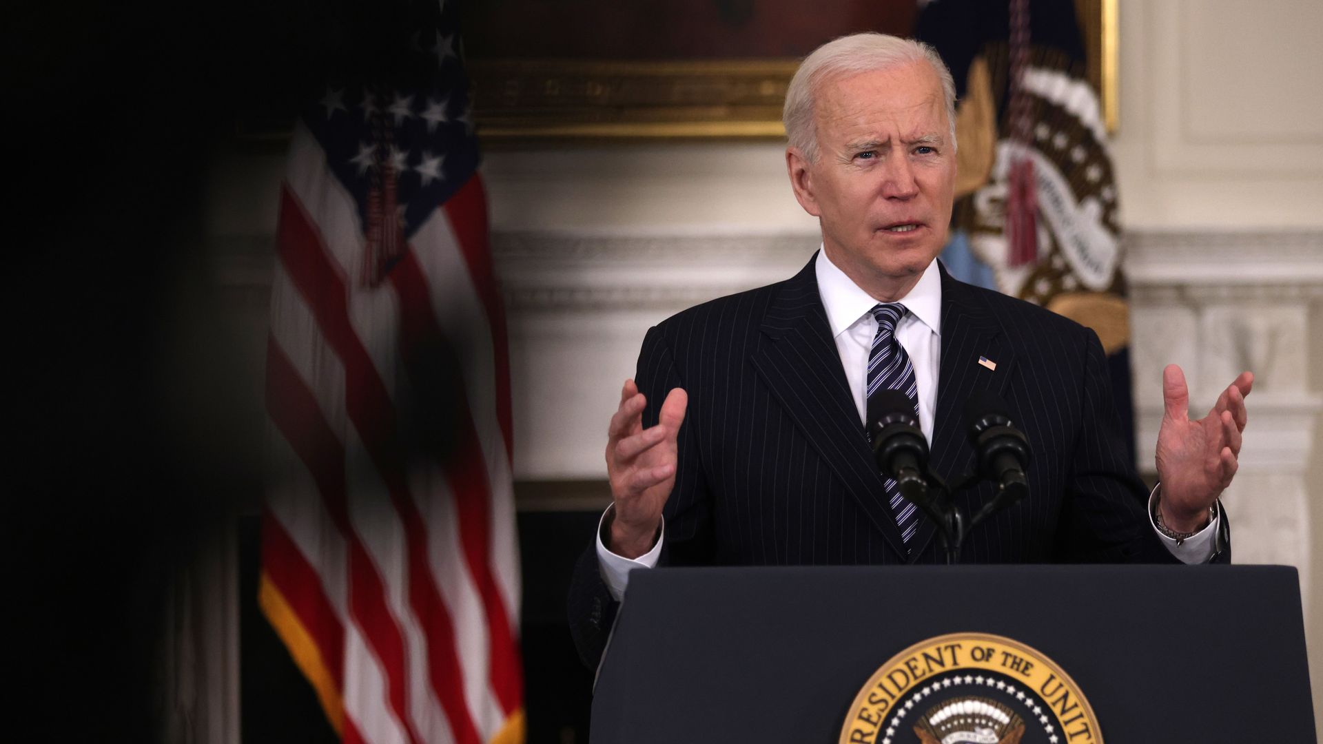 President Biden speaks behind podium