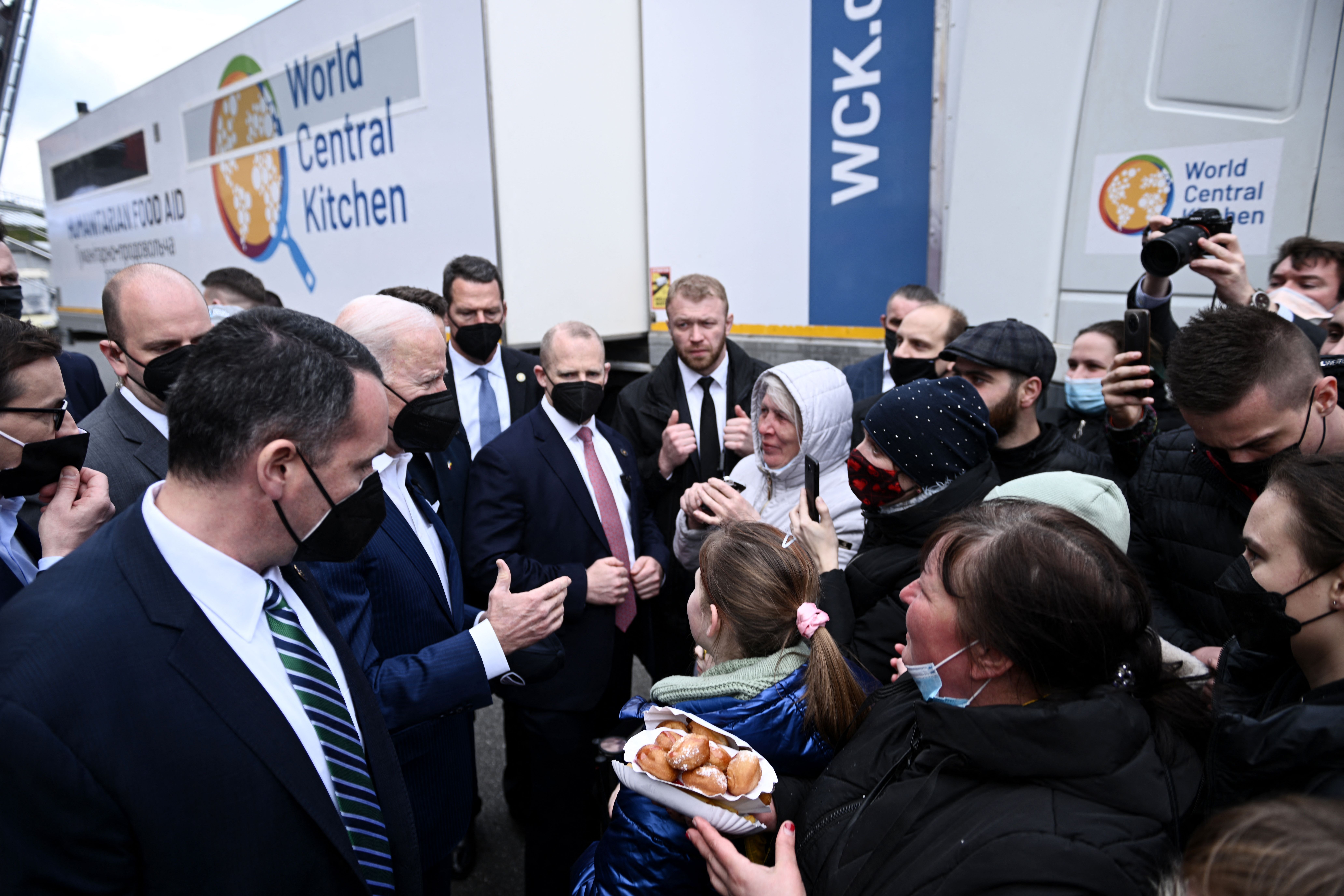 President Joe Biden (C) meets with Ukrainian refugees at PGE Narodowy Stadium in Warsaw on March 26, 2022