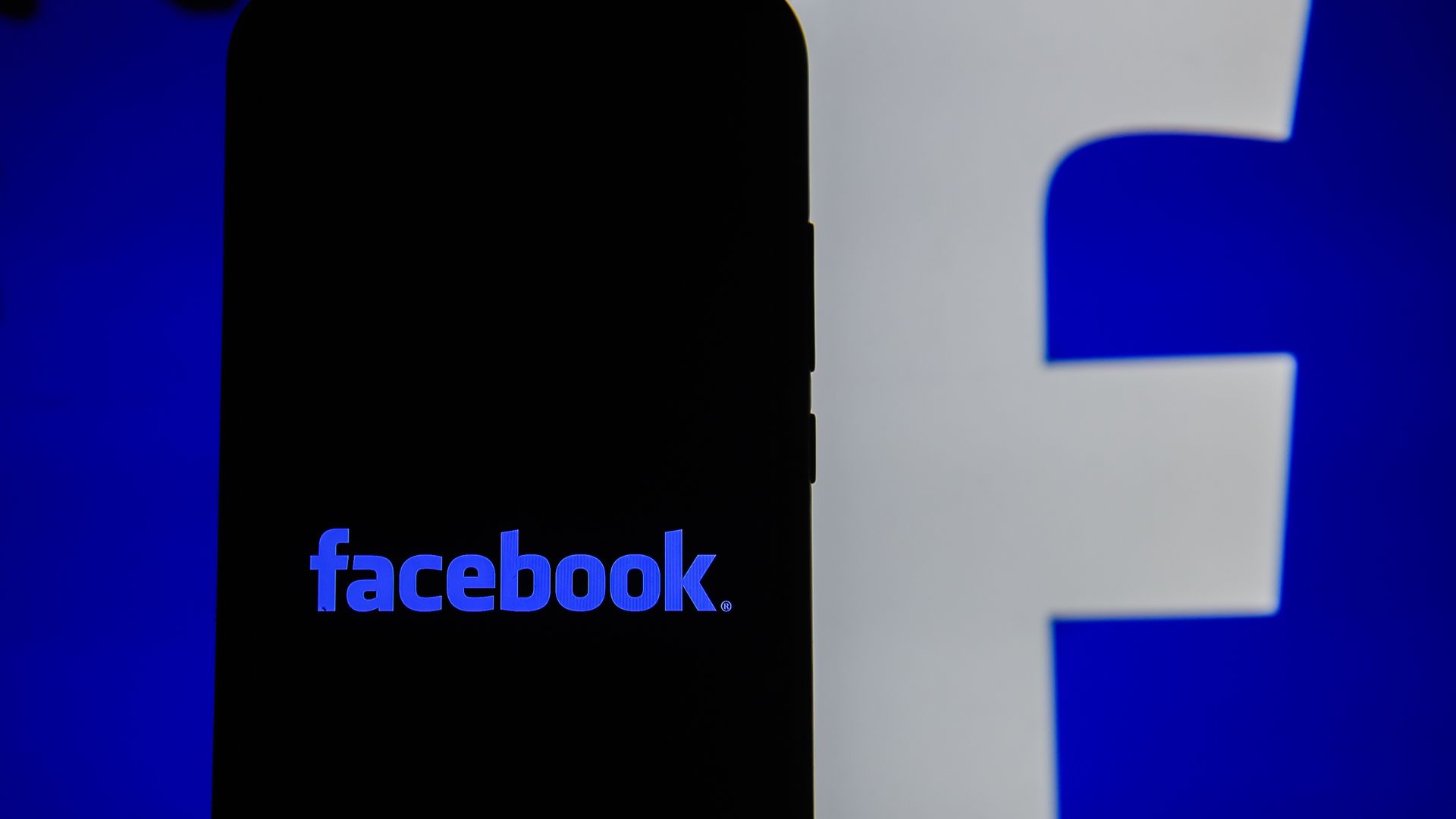 Facebook logo on a phone screen