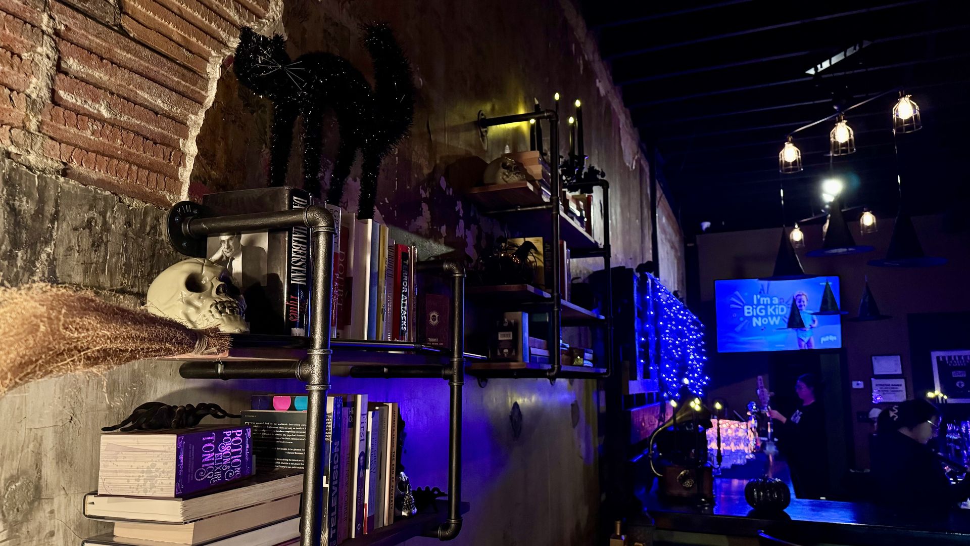 Decorations including a skull and a broom adorn the bar.