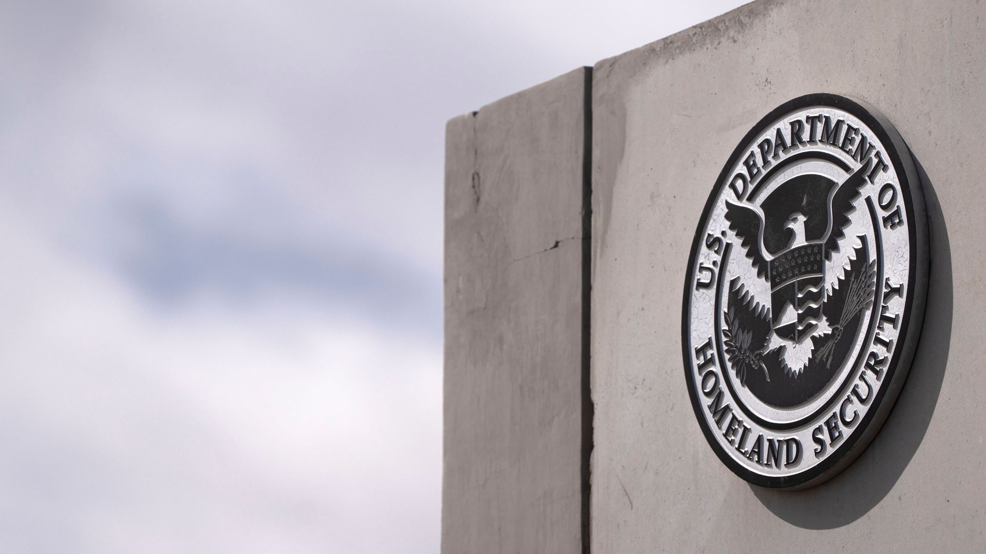 The seal of the US Department of Homeland Security outside the Nogales-Mariposa port of entry on the US-Mexico border in Nogales, Arizona, US, on Friday, Feb. 21, 2025. President Donald Trump said he would likely impose tariffs on automobile, semiconductor and pharmaceutical imports of around 25%, a