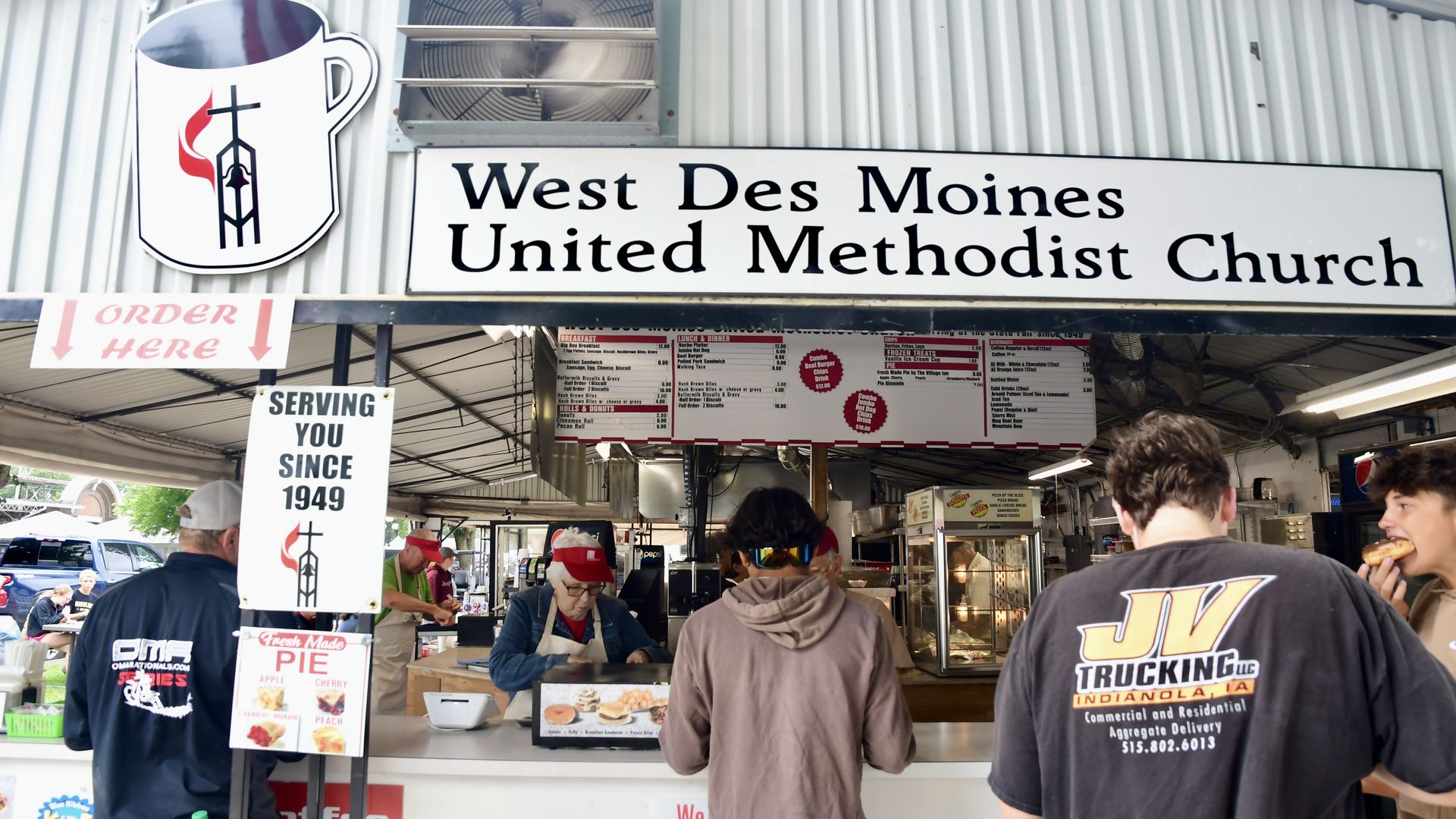 People ordering food at the west des moines united methodist church stand