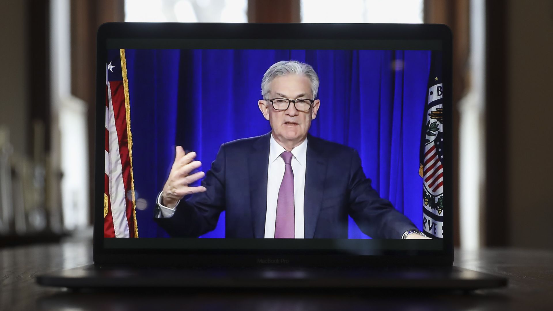 Fed chair Jerome Powell on a laptop