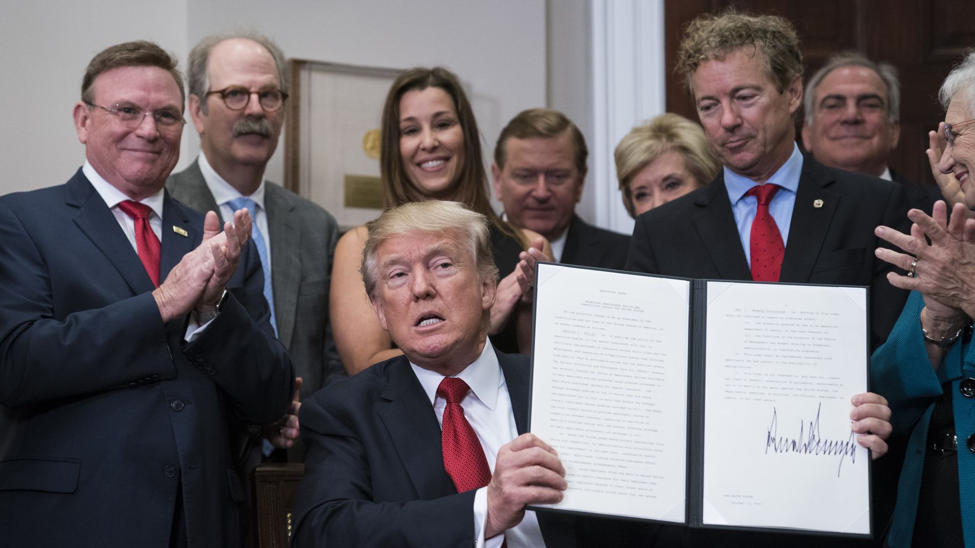 President Trump displays his executive order on health care