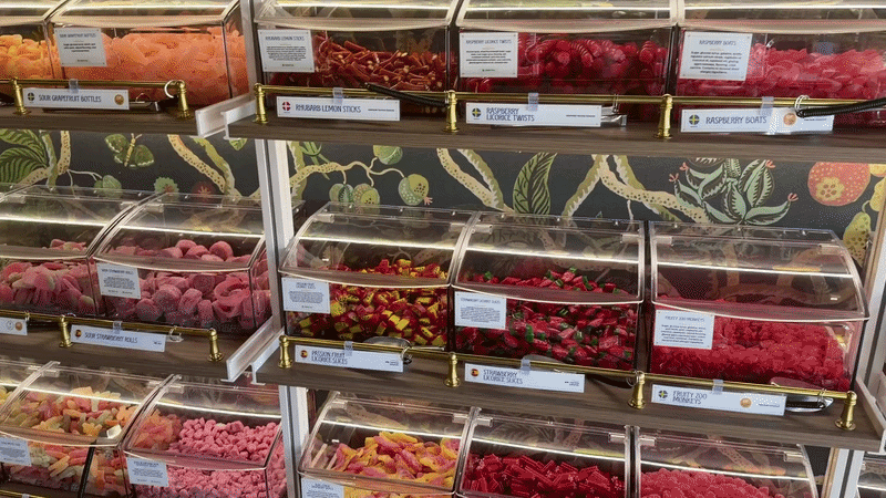 a video of rows and rows of candy, going from red to pink, green yellow and more