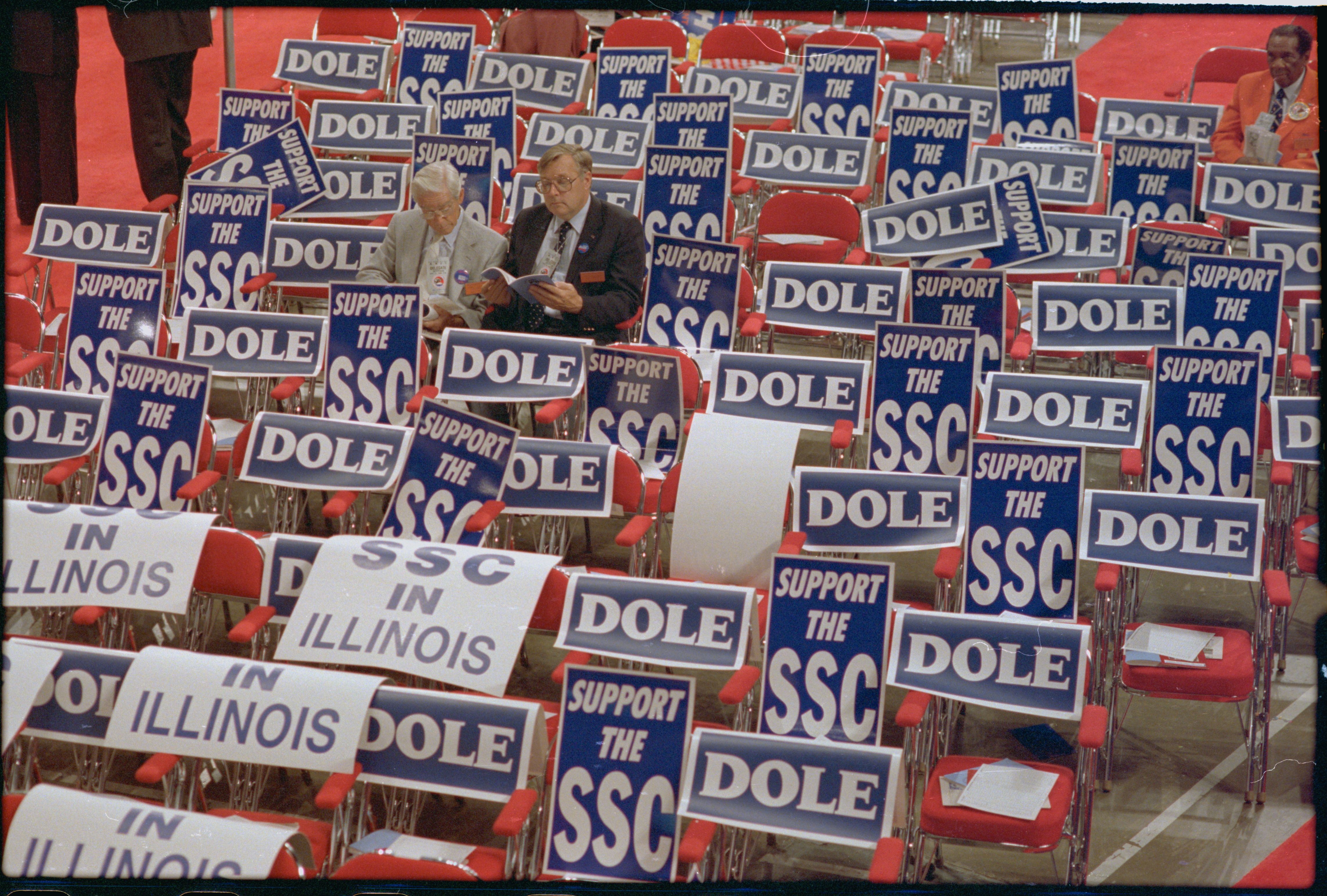 Photo shows empty seats covered in blue and white "Dole" signs