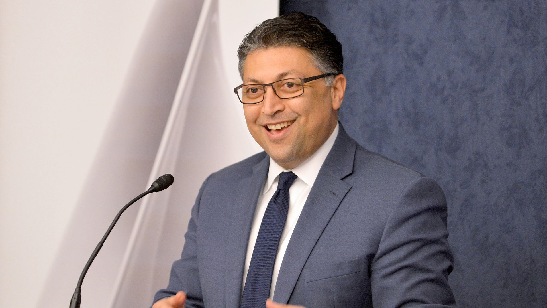 A photo of Makan Delrahim standing at a podium.