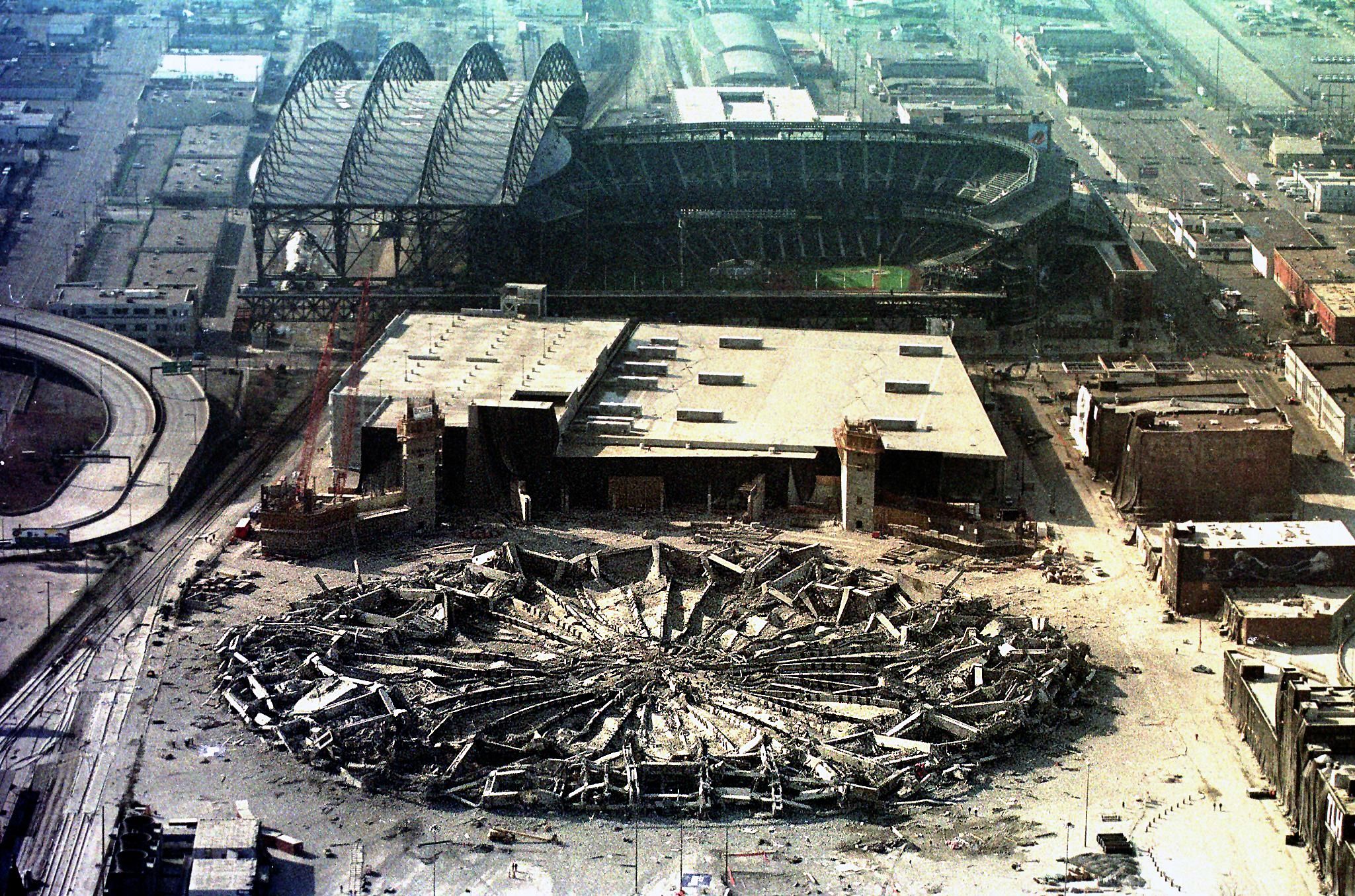 The Kingdome shown after its collapse, in a heap of concrete on the ground.