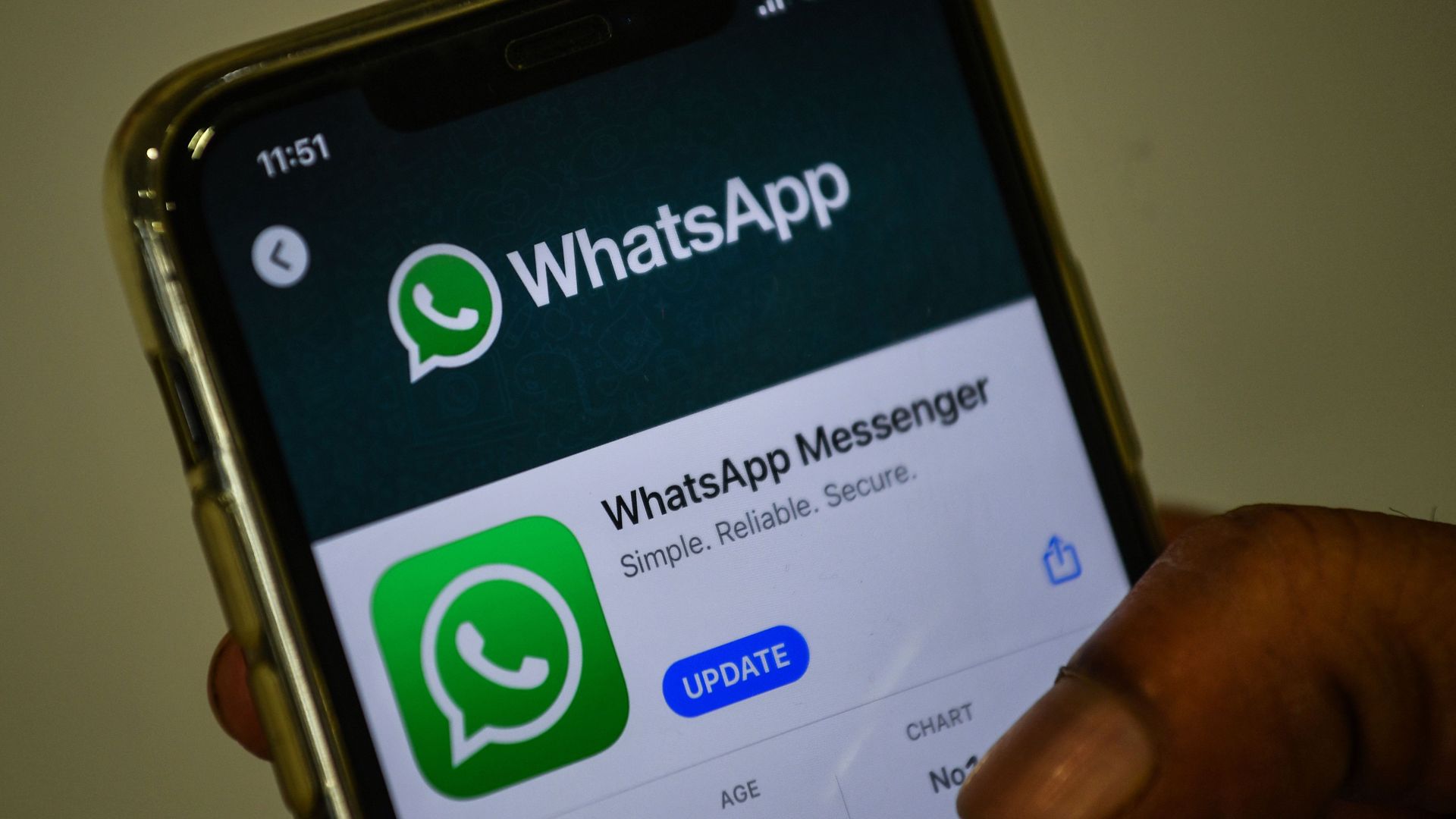 In this photo illustration taken on November 6, 2020, a user updates Facebook's WhatsApp application on his mobile phone in Mumbai. 